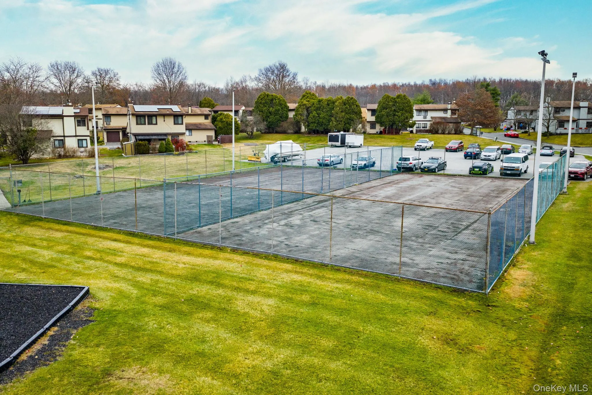 View of tennis court with a residential view View of tennis court with a residential view