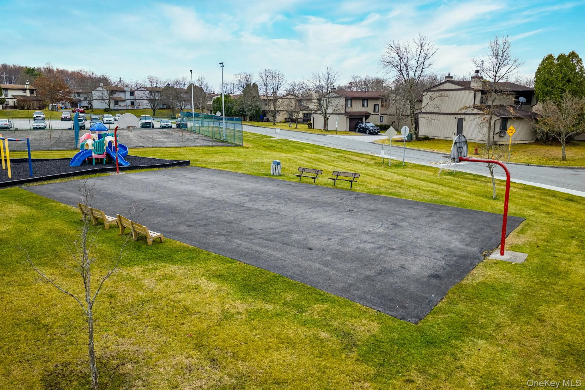 View of property's community with a yard, community basketball court, and a residential view View of property's community with a yard, community basketball court, and a residential view