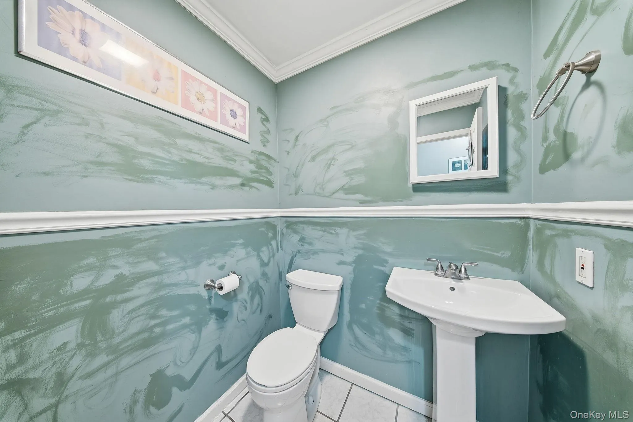 Half bathroom with crown molding and tile patterned flooring Half bathroom with crown molding and tile patterned flooring