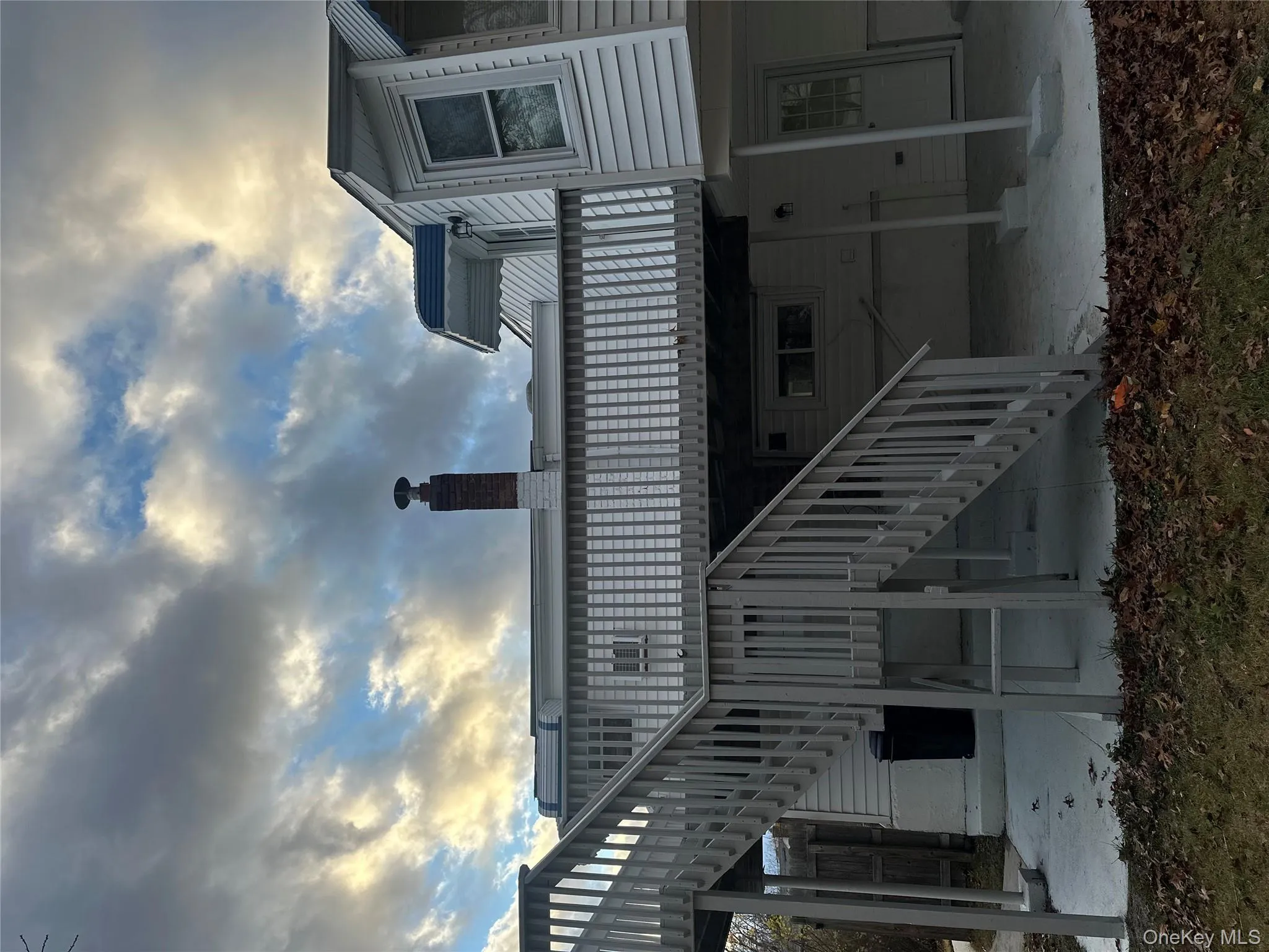 Rear view of property featuring a patio, a deck, stairway, and a chimney Rear view of property featuring a patio, a deck, stairway, and a chimney