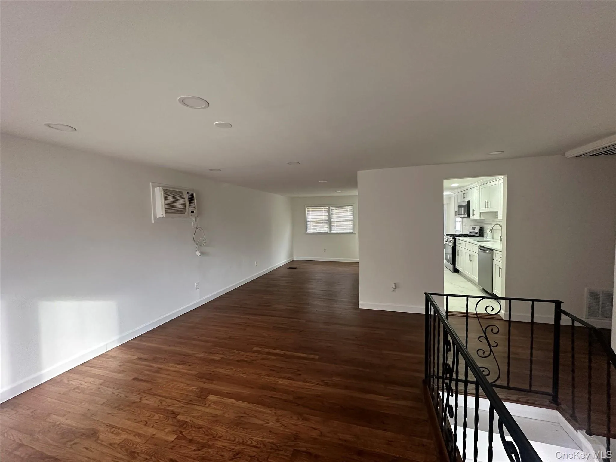 Unfurnished room with dark wood-type flooring and recessed lighting Unfurnished room with dark wood-type flooring and recessed lighting