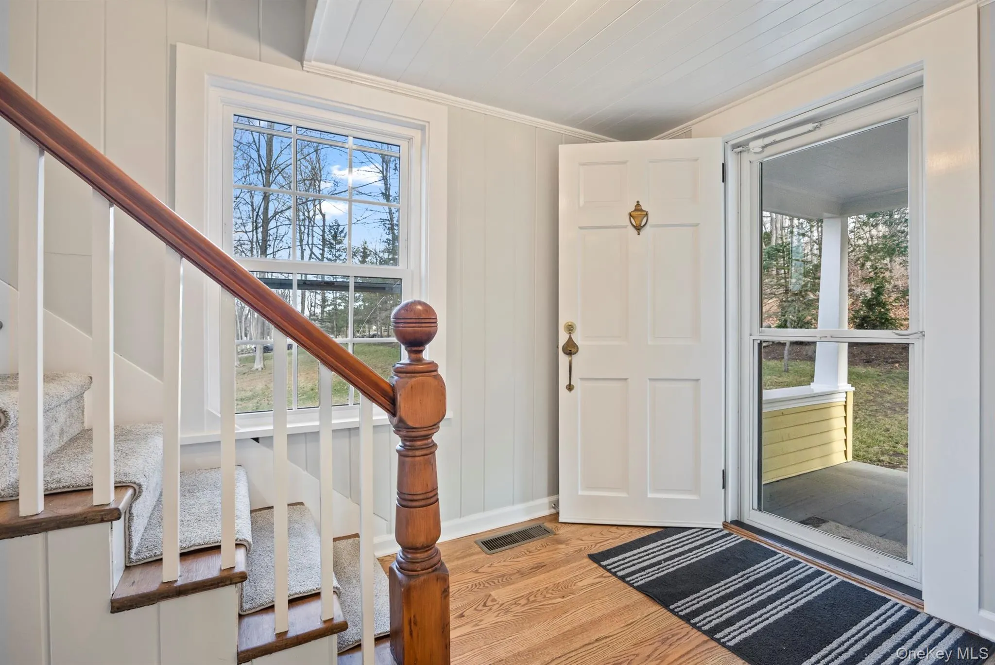 Foyer featuring stairway and light wood-style floors Foyer featuring stairway and light wood-style floors