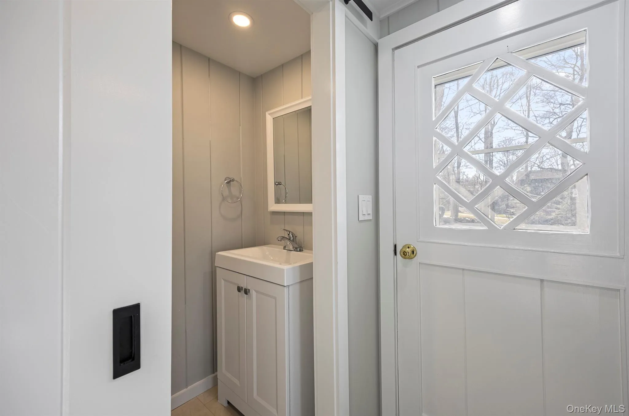 Bathroom featuring vanity, recessed lighting, and light tile patterned floors Bathroom featuring vanity, recessed lighting, and light tile patterned floors