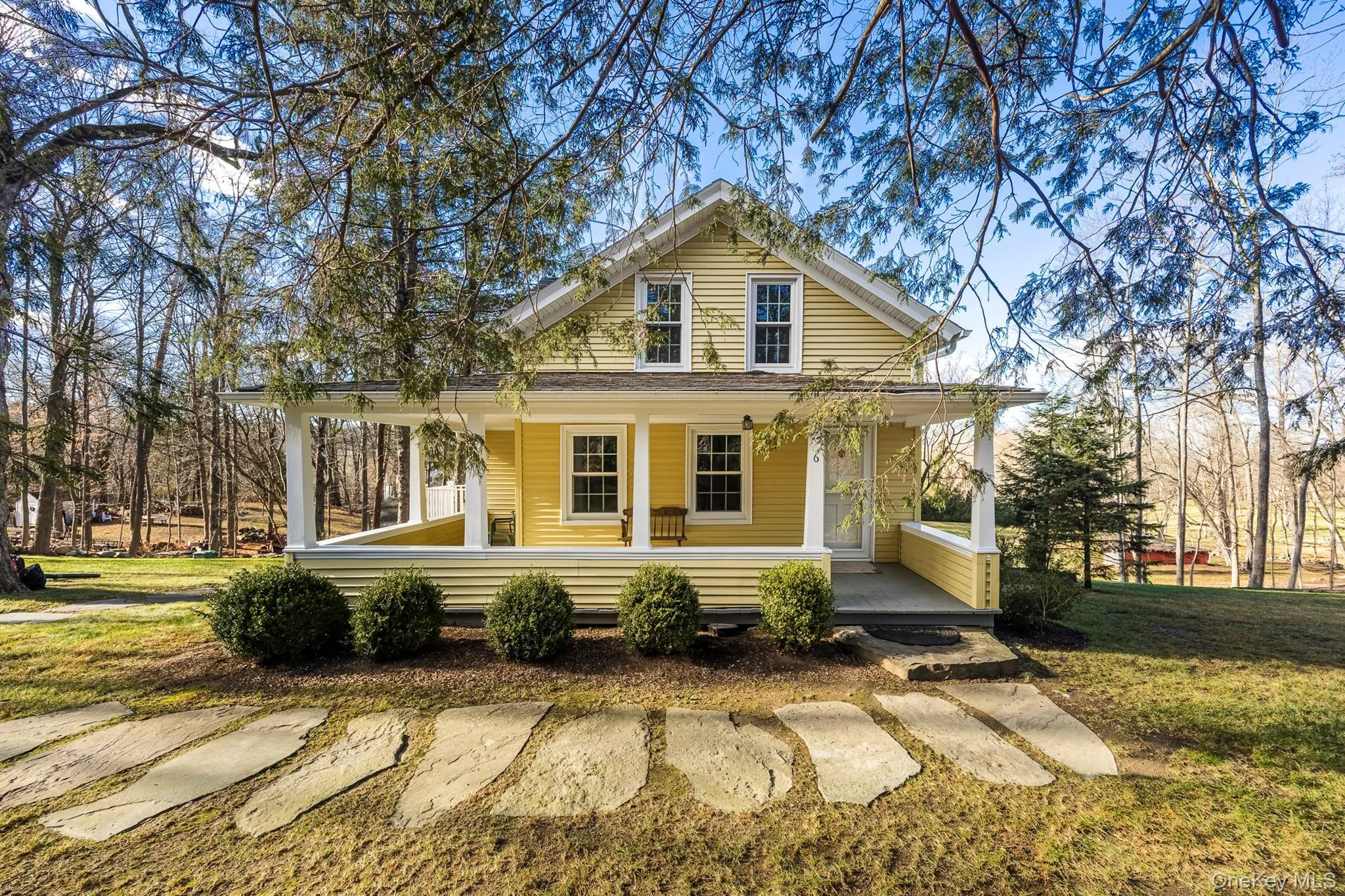 View of front of home with covered porch and a front yard View of front of home with covered porch and a front yard