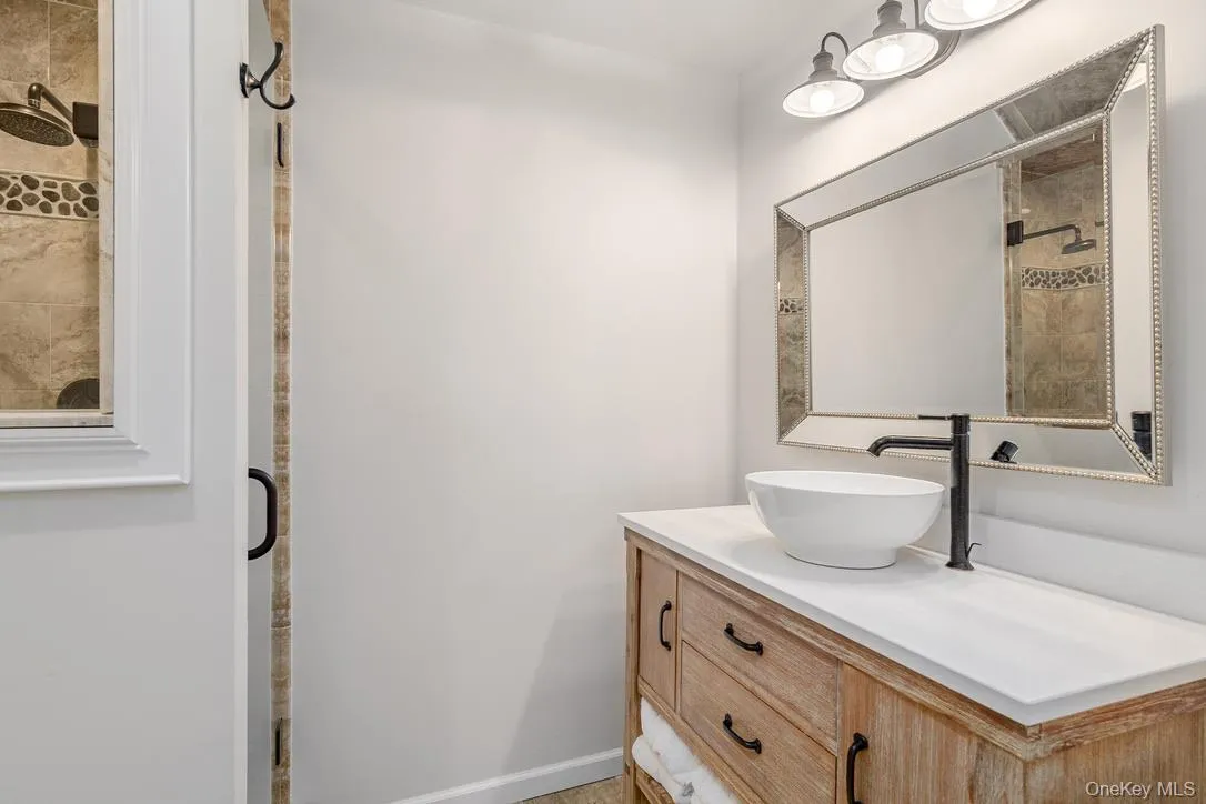 Bathroom with vanity and a stall shower Bathroom with vanity and a stall shower