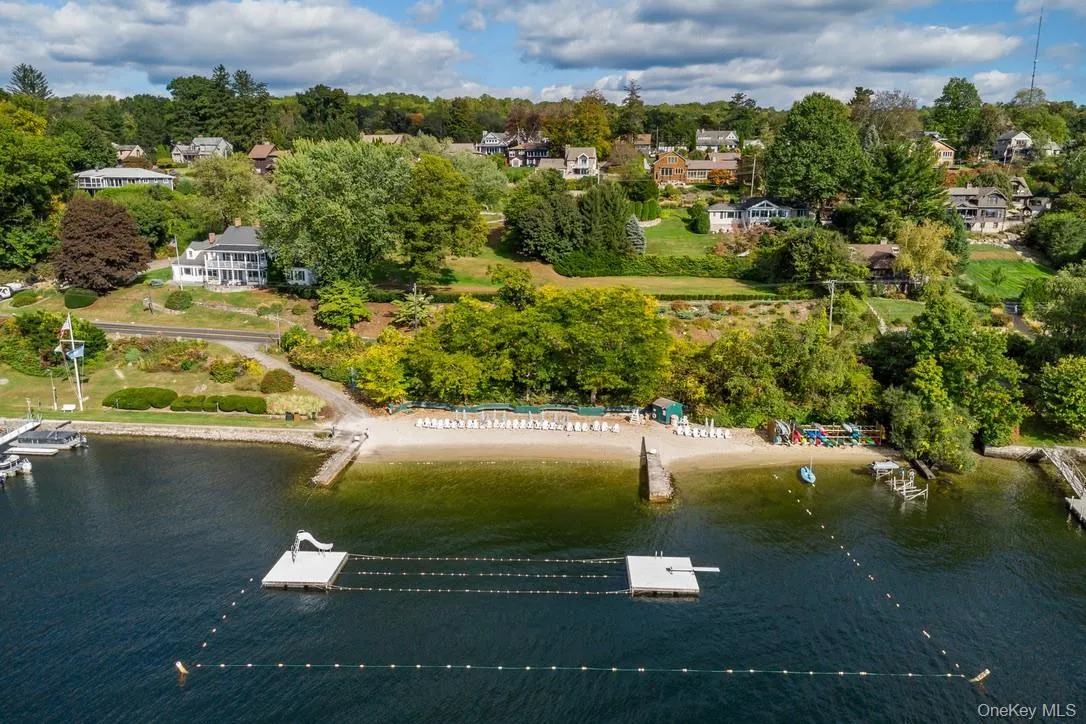 Aerial view of property's location with a large body of water and nearby suburban area Aerial view of property's location with a large body of water and nearby suburban area
