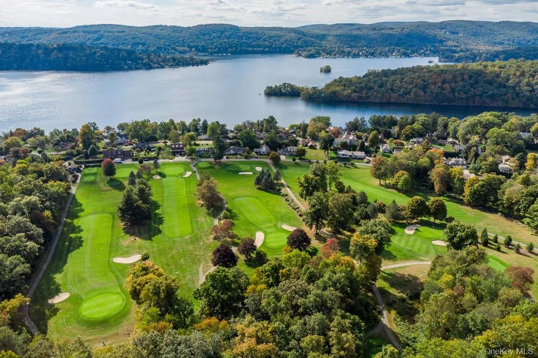 Aerial perspective of suburban area featuring a large body of water and a local golf course Aerial perspective of suburban area featuring a large body of water and a local golf course