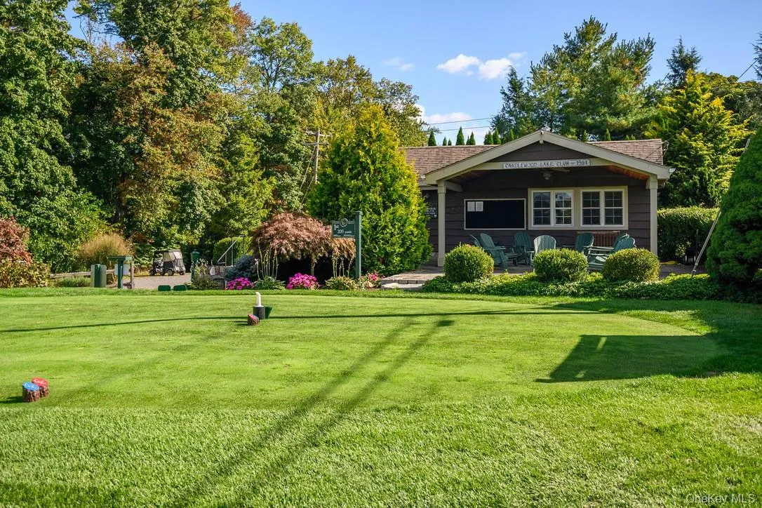 Rear view of property featuring a lawn and covered porch Rear view of property featuring a lawn and covered porch