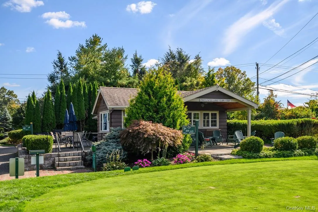 Rear view of house featuring a patio area, a yard, and outdoor dining area Rear view of house featuring a patio area, a yard, and outdoor dining area