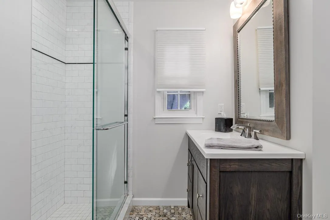 Bathroom featuring vanity and a shower stall Bathroom featuring vanity and a shower stall