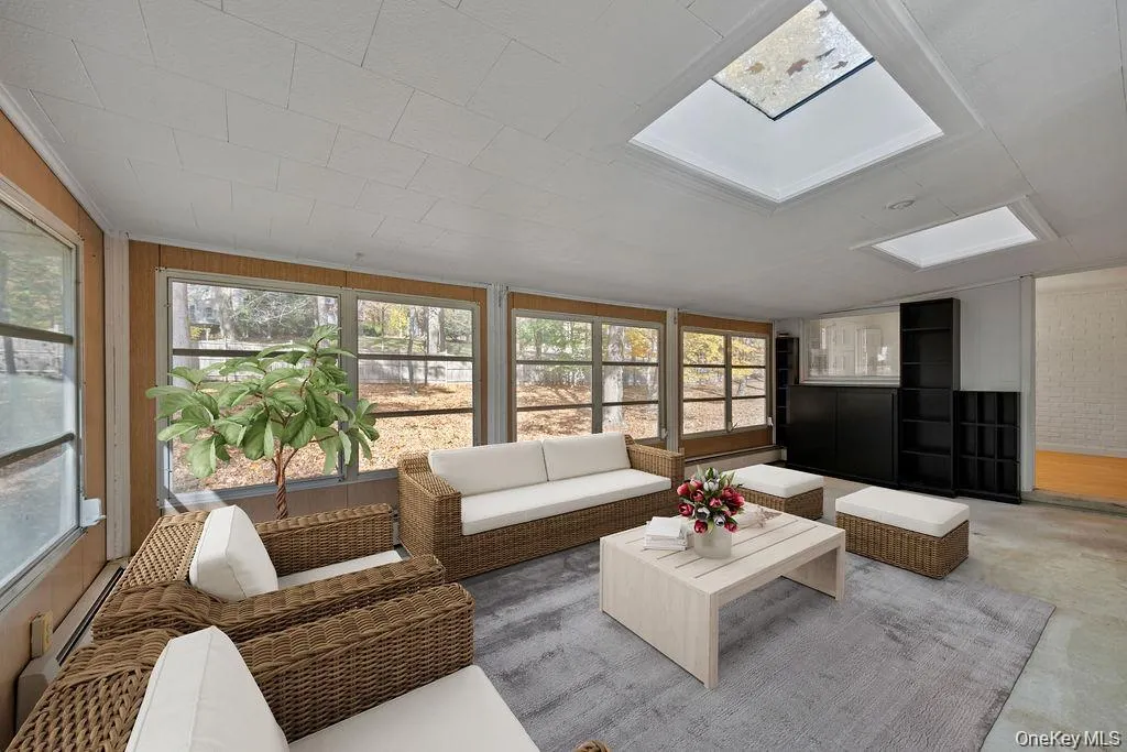 Sunroom / solarium with a skylight and baseboard heating Sunroom / solarium with a skylight and baseboard heating