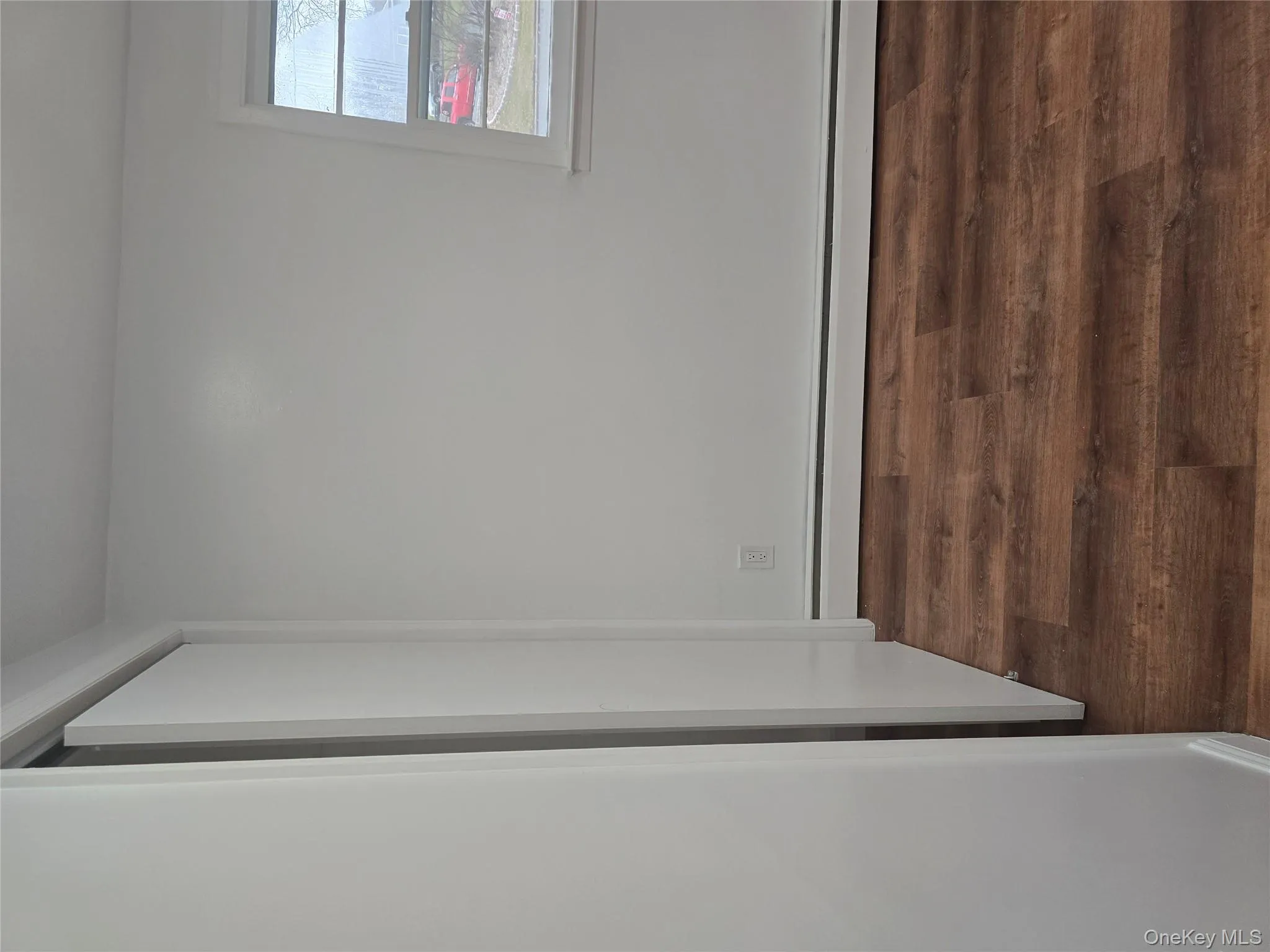 Unfurnished bedroom with baseboard heating and dark wood finished floors Unfurnished bedroom with baseboard heating and dark wood finished floors