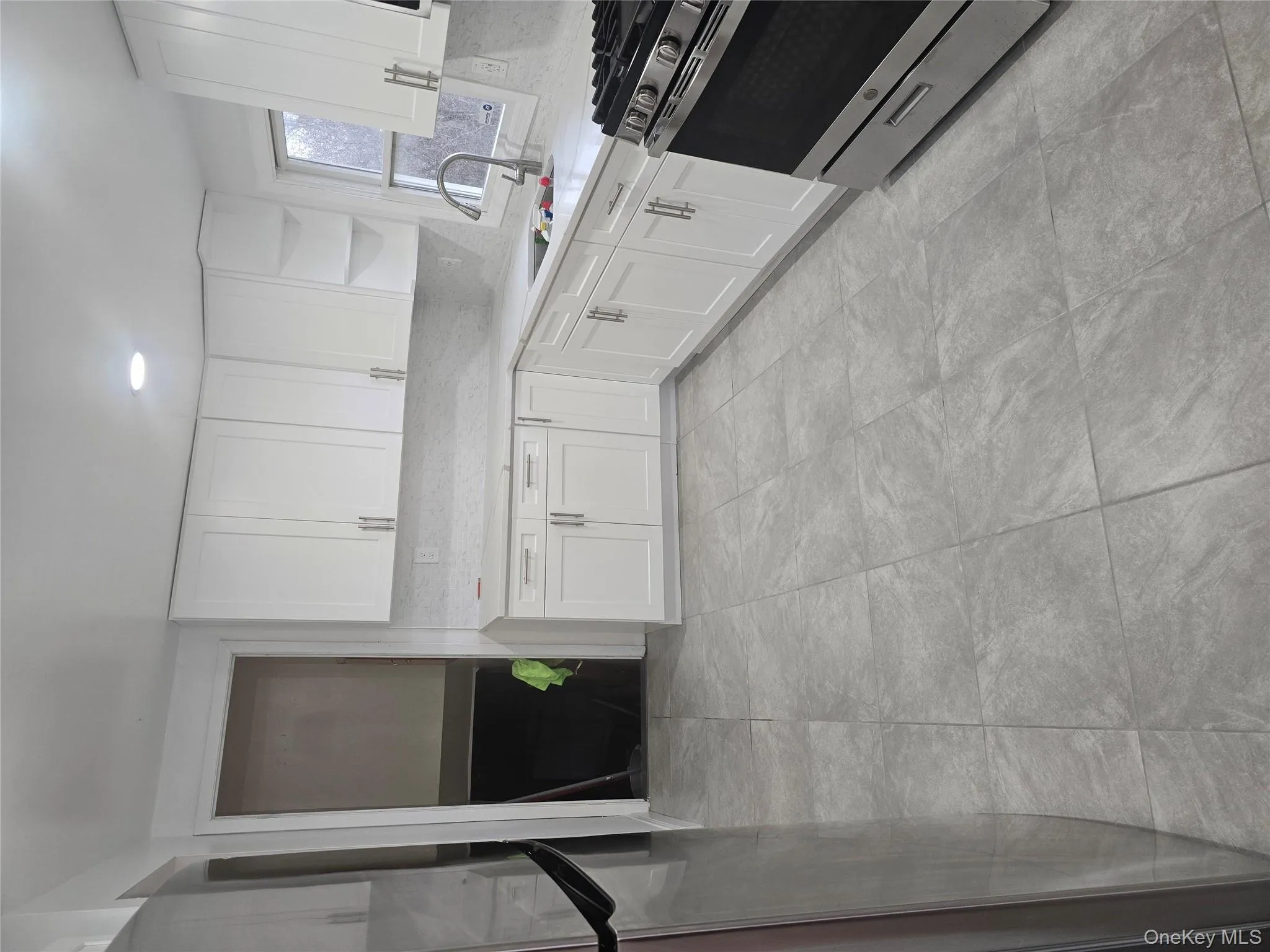 Kitchen featuring range, open shelves, white cabinetry, and refrigerator Kitchen featuring range, open shelves, white cabinetry, and refrigerator