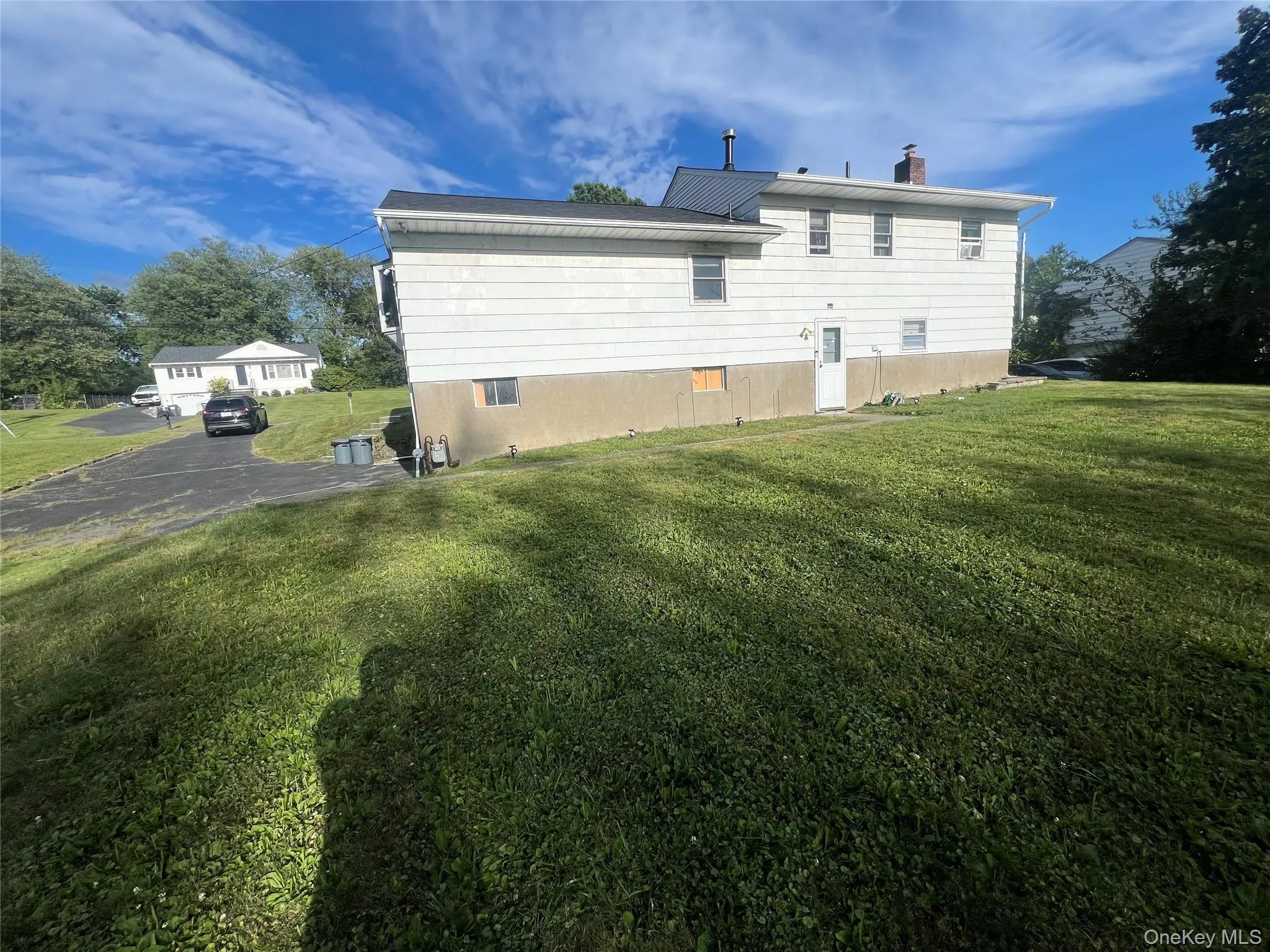 Rear view of property with a yard and a chimney Rear view of property with a yard and a chimney