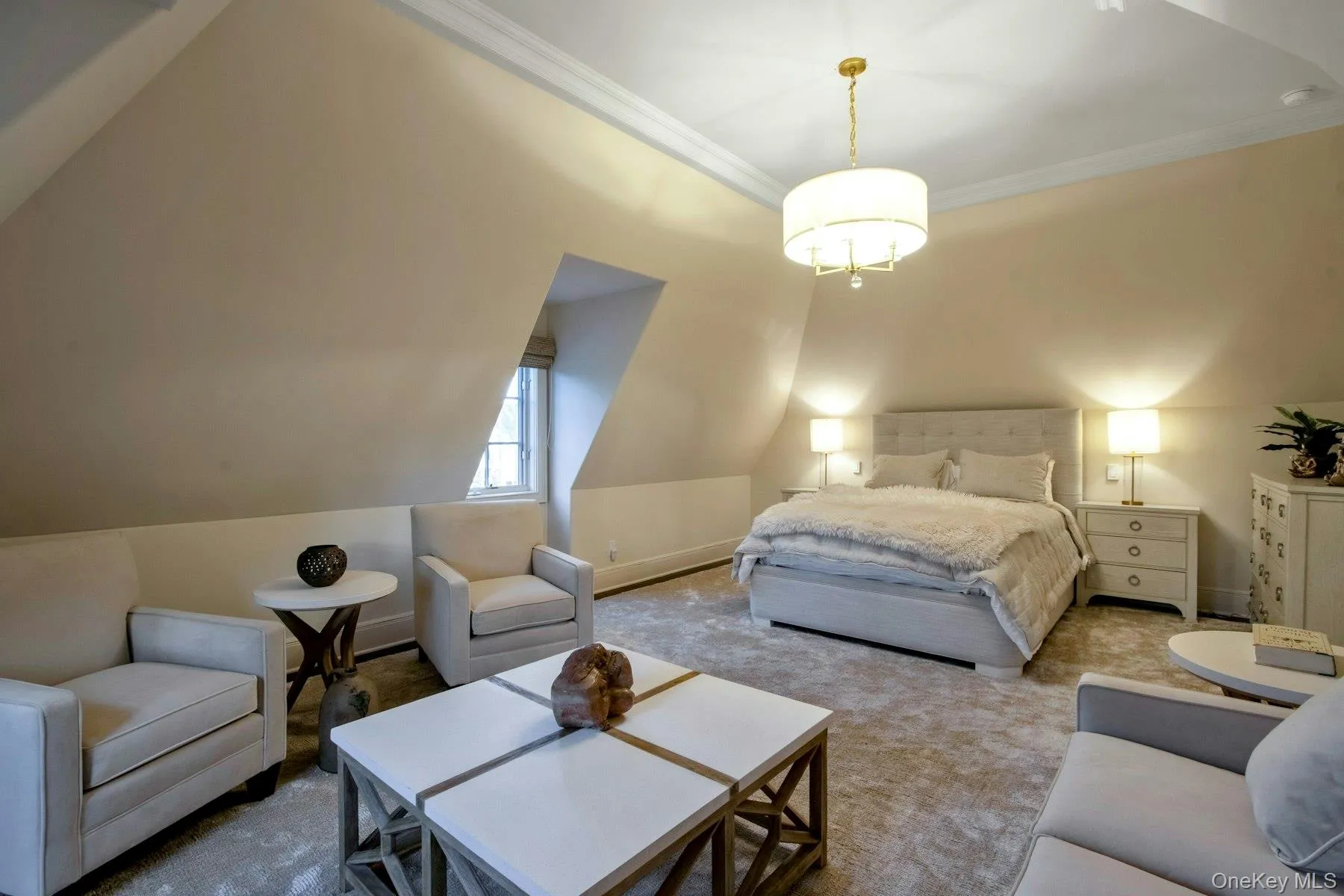 Carpeted bedroom featuring lofted ceiling and ornamental molding Carpeted bedroom featuring lofted ceiling and ornamental molding