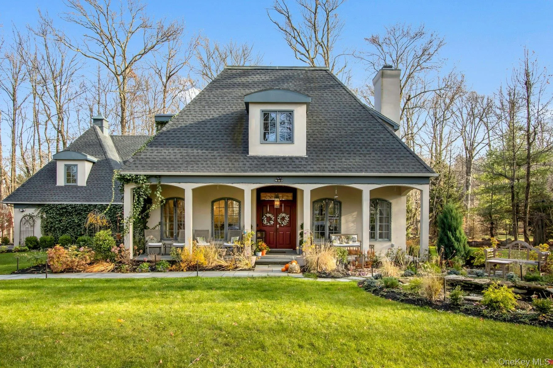View of front of home with a front lawn and a porch View of front of home with a front lawn and a porch