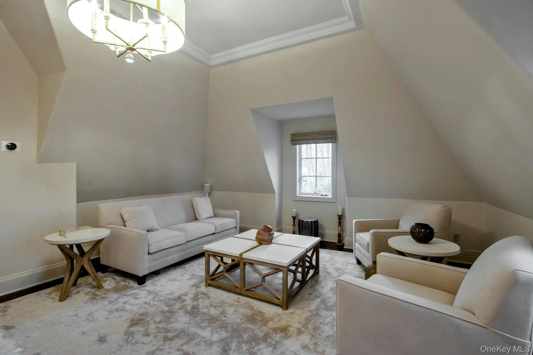 Bedroom featuring vaulted ceiling, light hardwood / wood-style flooring, a notable chandelier, and crown molding Bedroom featuring vaulted ceiling, light hardwood / wood-style flooring, a notable chandelier, and crown molding