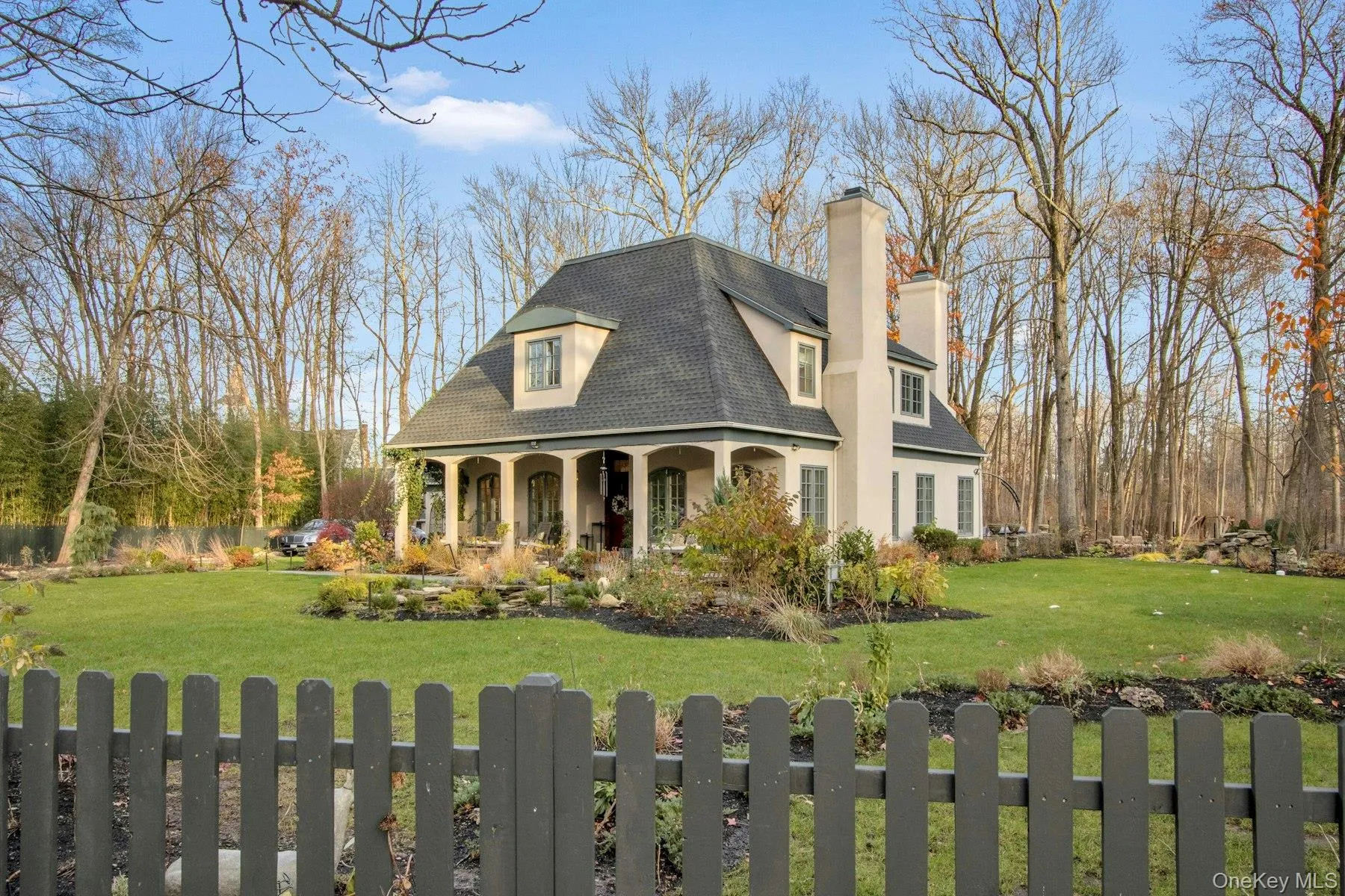 View of front facade with covered porch and a front yard View of front facade with covered porch and a front yard