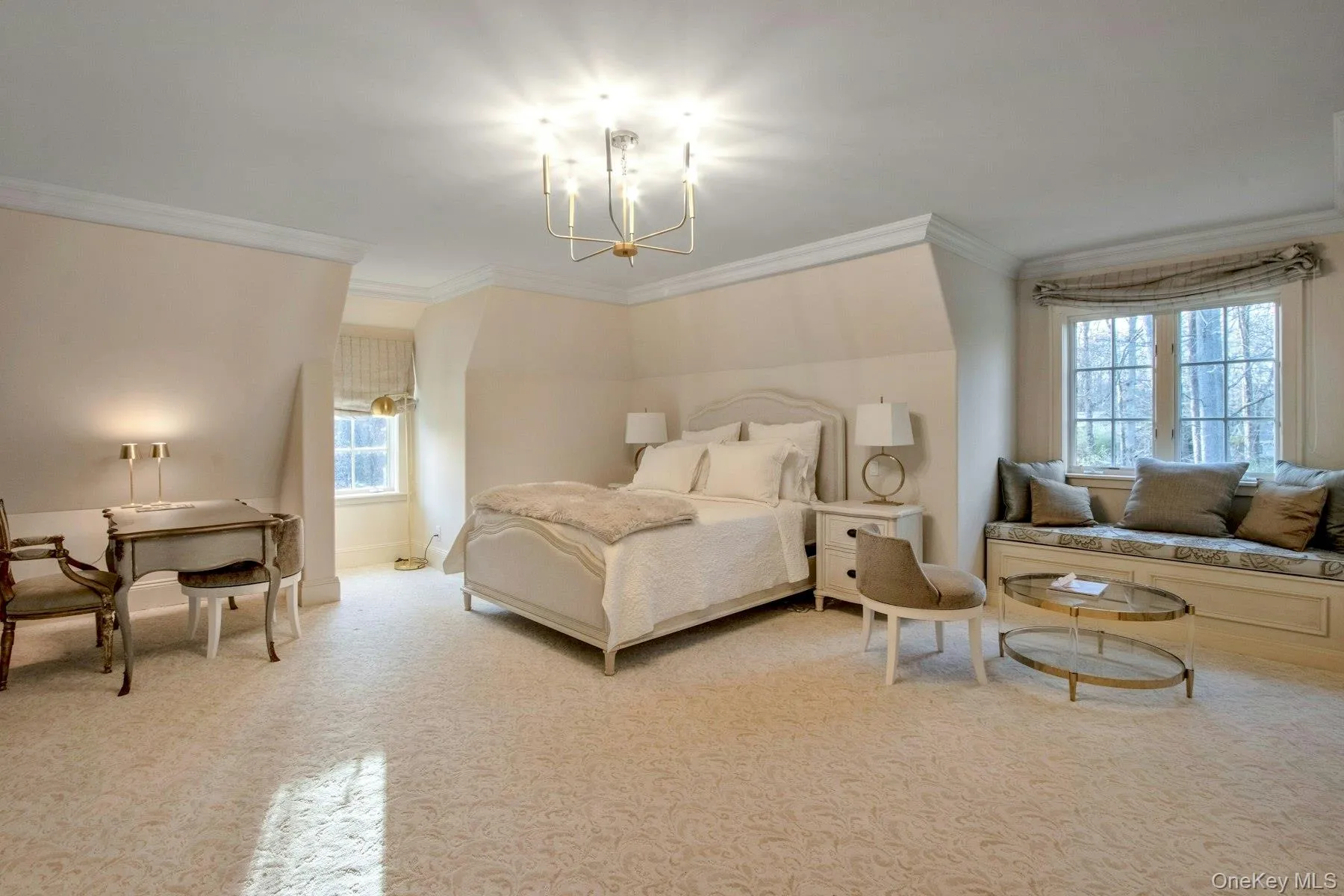 Carpeted bedroom featuring a notable chandelier and ornamental molding Carpeted bedroom featuring a notable chandelier and ornamental molding