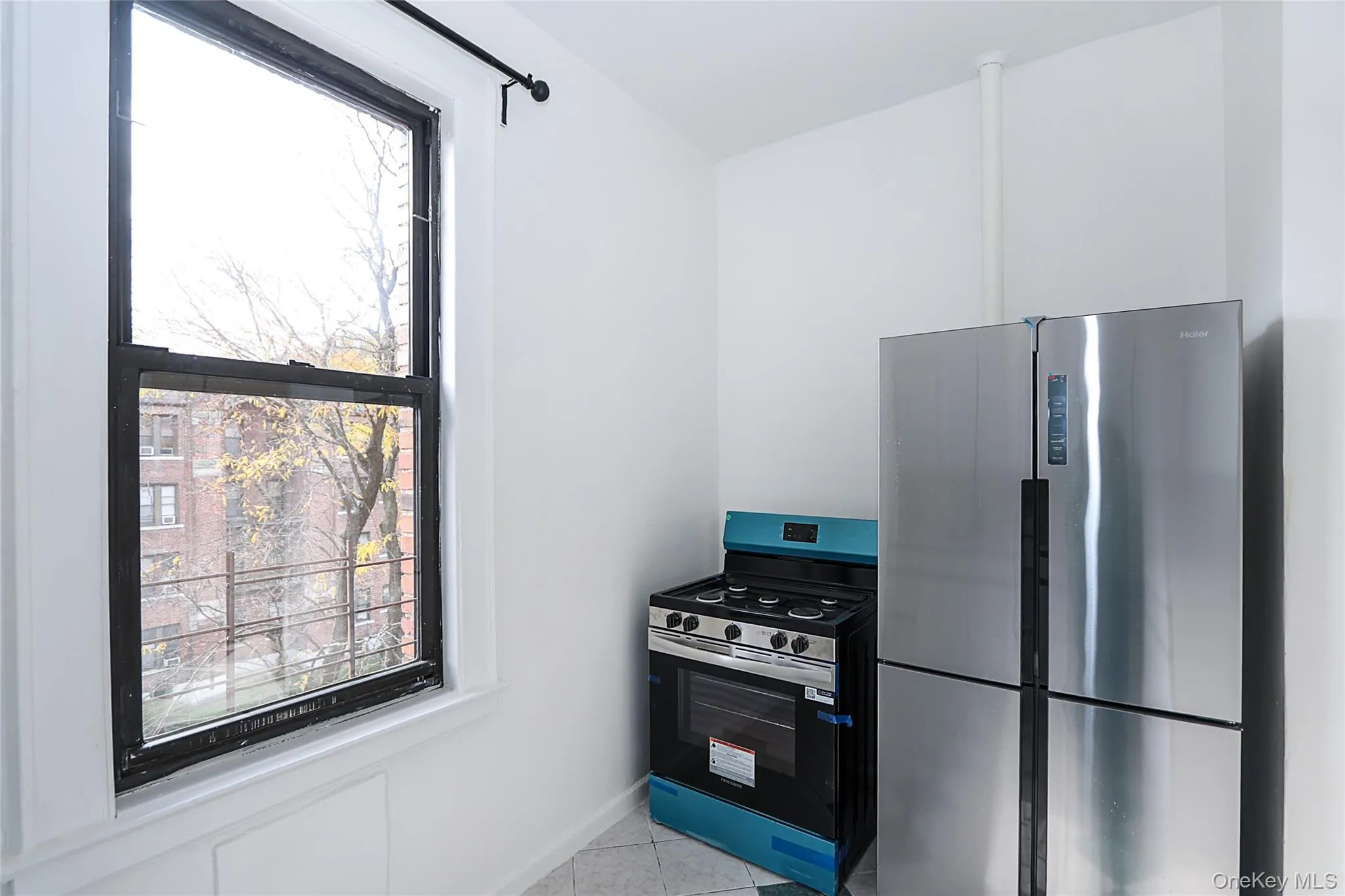 Kitchen featuring stainless steel appliances and light tile patterned flooring Kitchen featuring stainless steel appliances and light tile patterned flooring