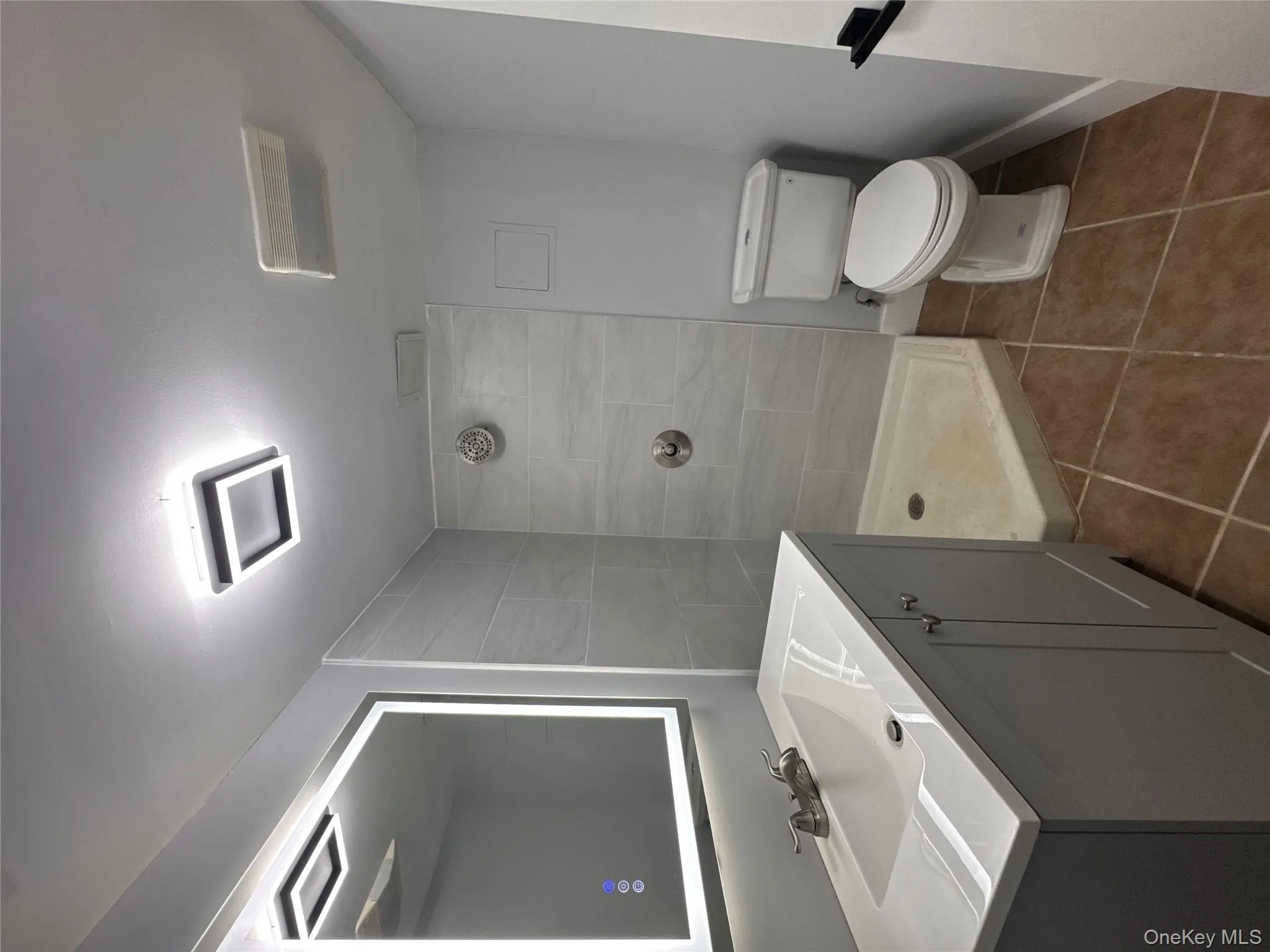 Full bath with vanity, tile patterned flooring, and a stall shower Full bath with vanity, tile patterned flooring, and a stall shower