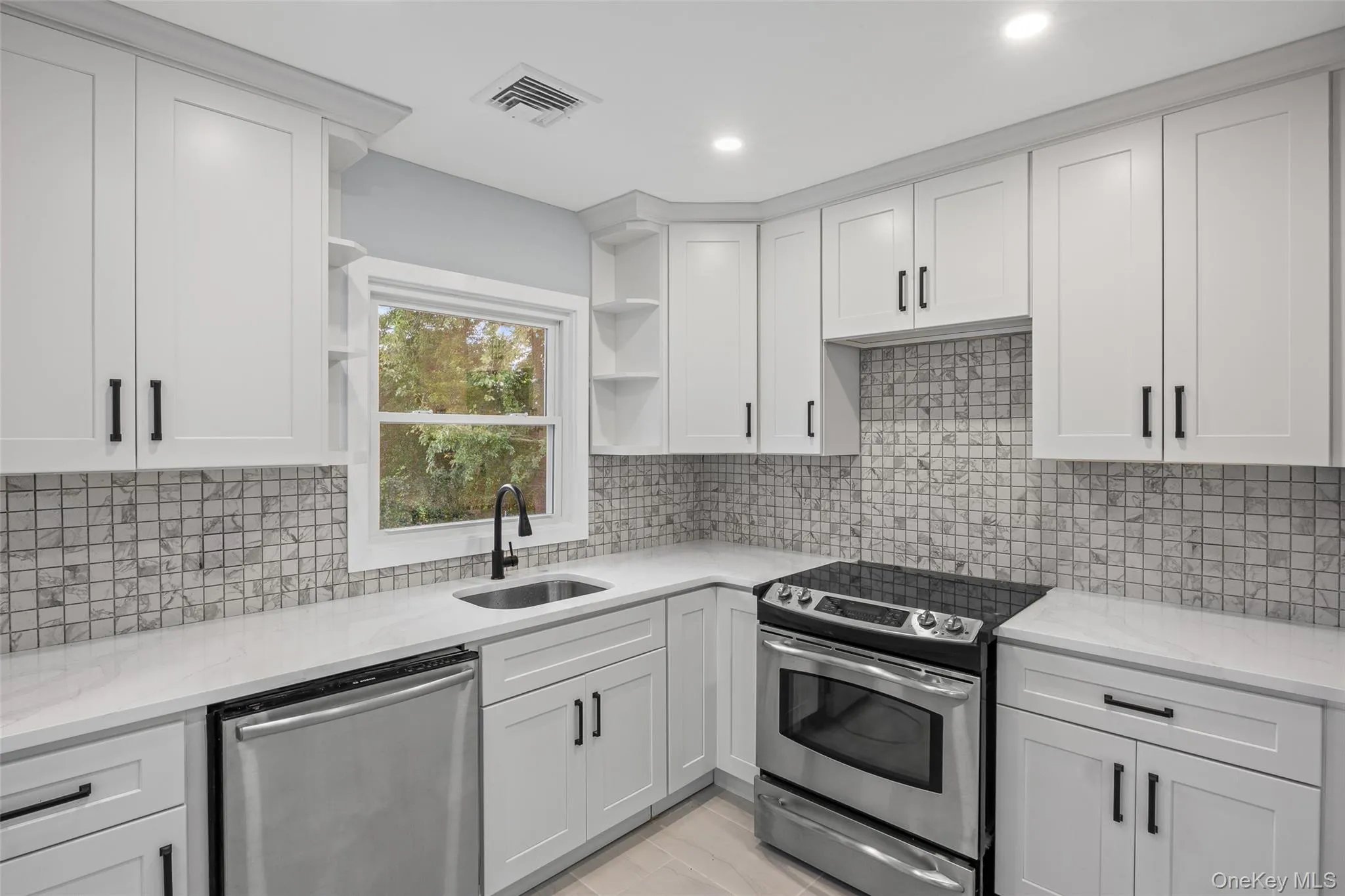 Kitchen featuring open shelves, appliances with stainless steel finishes, light stone countertops, decorative backsplash, and recessed lighting Kitchen featuring open shelves, appliances with stainless steel finishes, light stone countertops, decorative backsplash, and recessed lighting