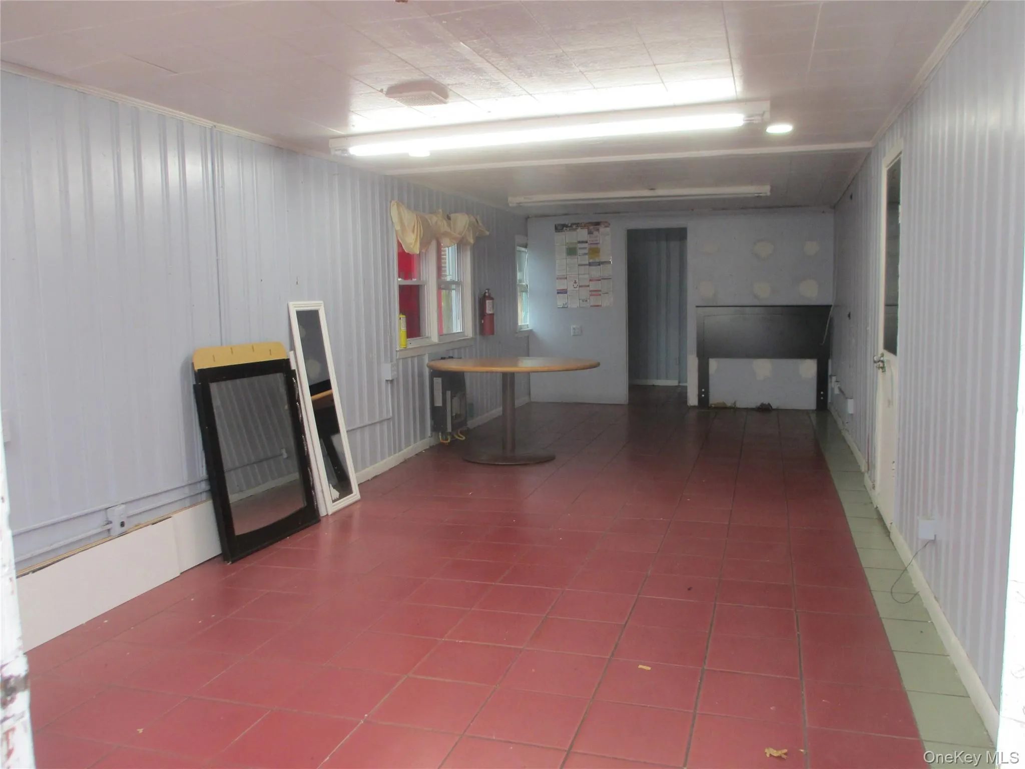 Below grade area featuring tile patterned flooring Below grade area featuring tile patterned flooring