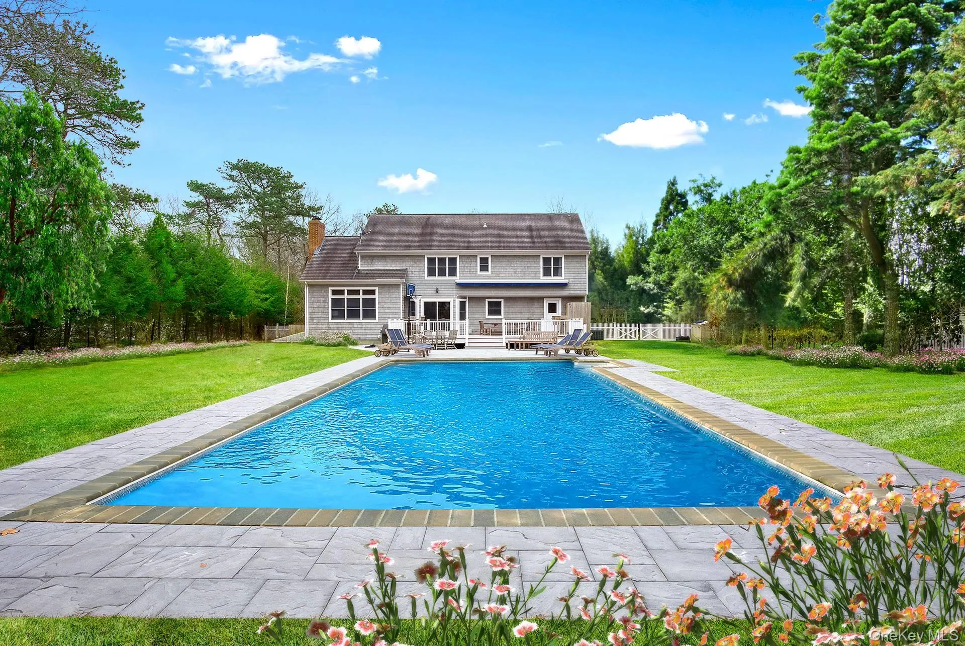View of pool featuring a patio, a fenced backyard, and view of scattered trees View of pool featuring a patio, a fenced backyard, and view of scattered trees