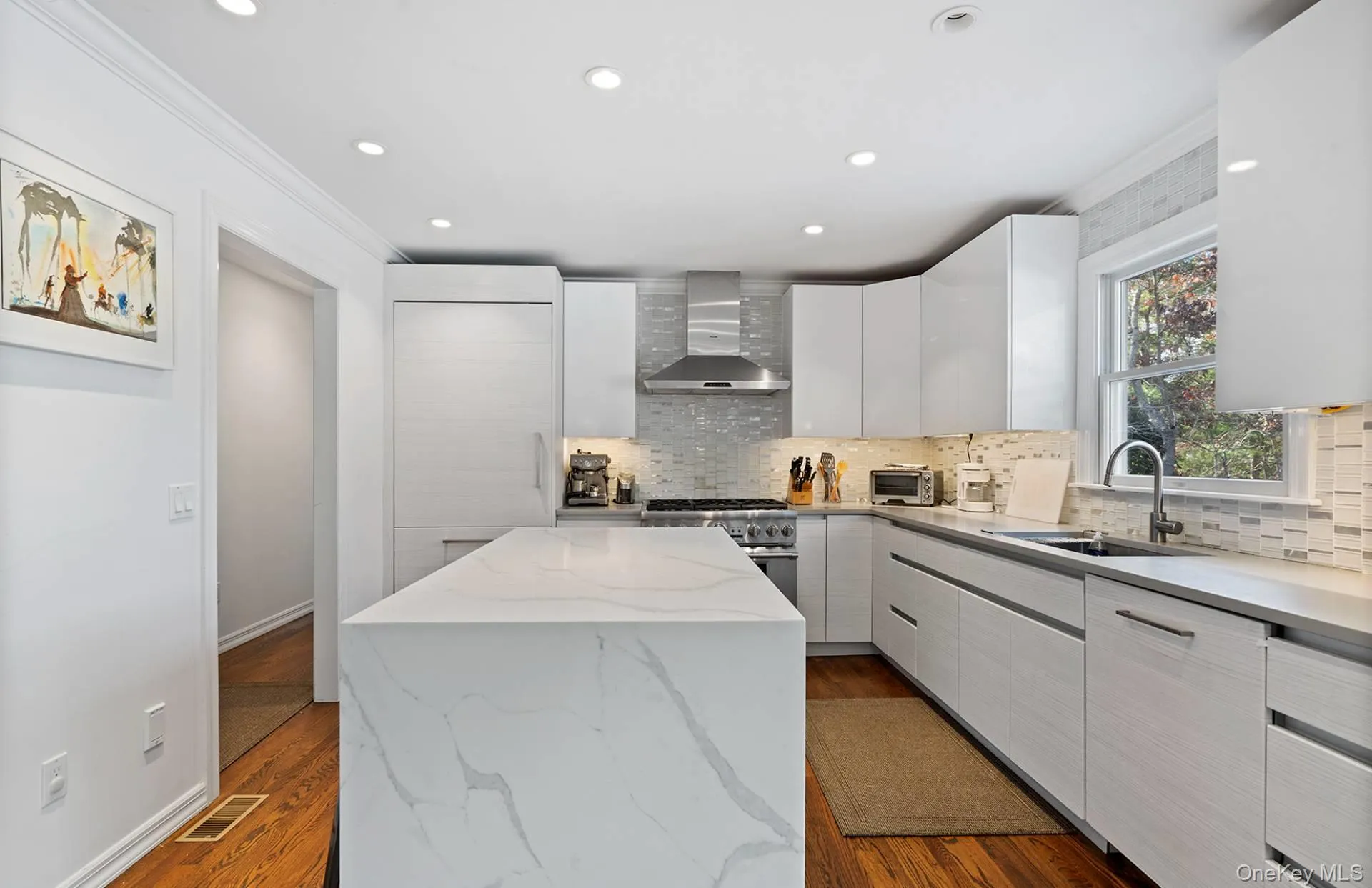 Kitchen featuring light stone counters, modern cabinets, recessed lighting, a center island, and high end stainless steel range oven Kitchen featuring light stone counters, modern cabinets, recessed lighting, a center island, and high end stainless steel range oven