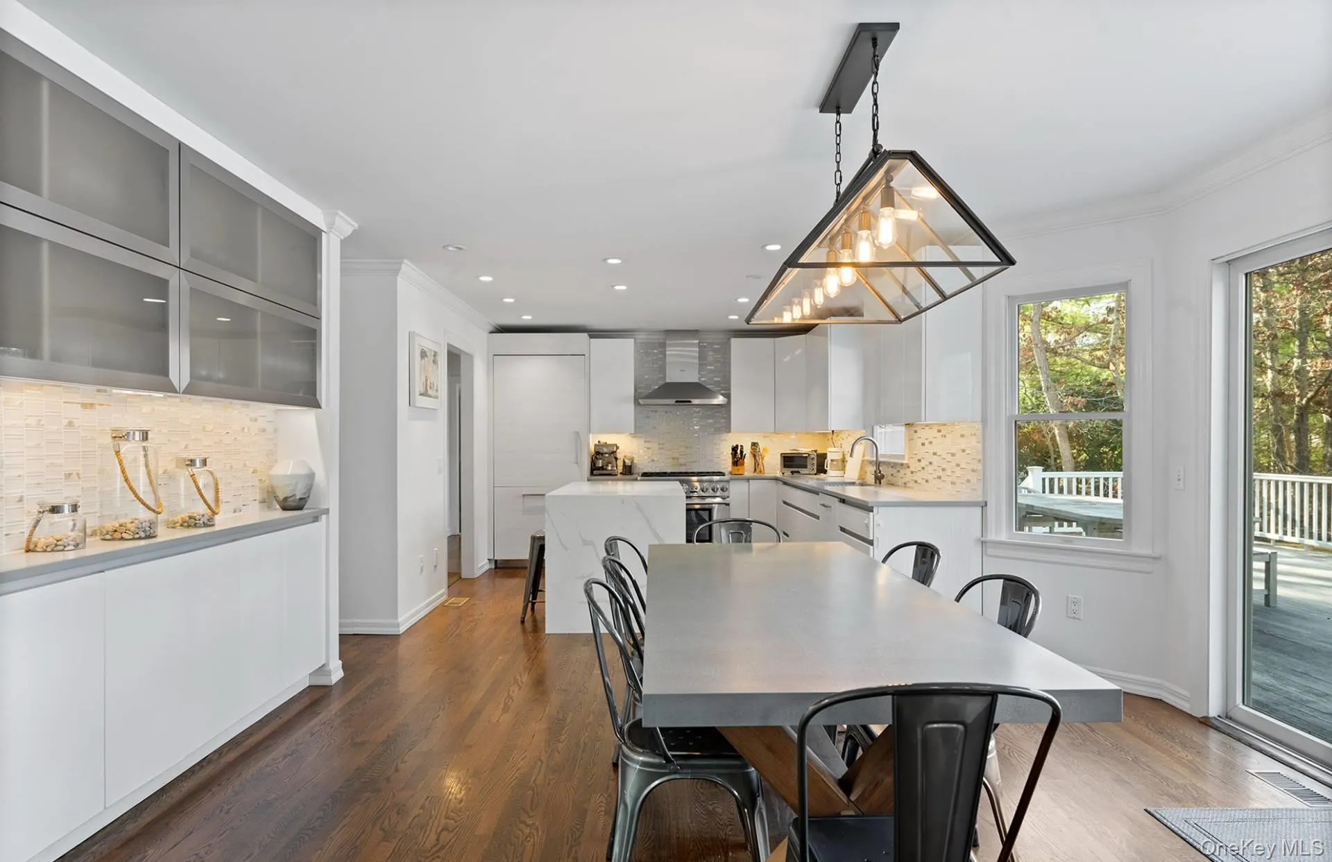 Dining area featuring ornamental molding, dark wood-type flooring, and recessed lighting Dining area featuring ornamental molding, dark wood-type flooring, and recessed lighting