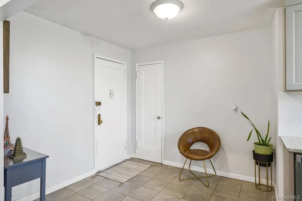 Foyer entrance with baseboards and light tile patterned floors Foyer entrance with baseboards and light tile patterned floors