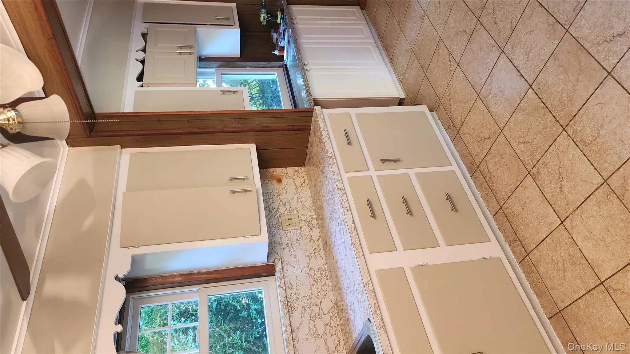 Kitchen featuring white cabinets and light stone countertops Kitchen featuring white cabinets and light stone countertops