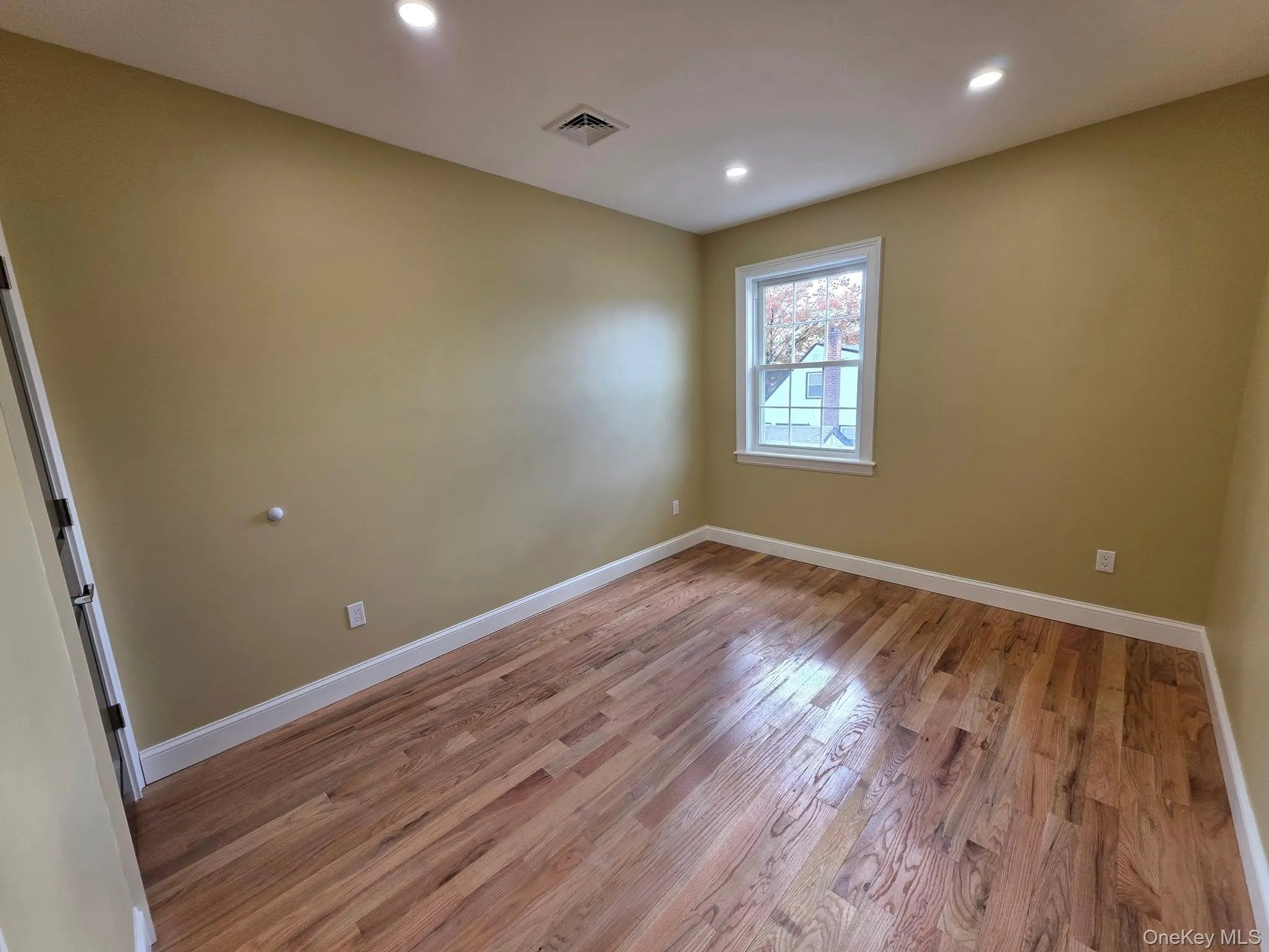 Unfurnished room with light wood-style floors and recessed lighting Unfurnished room with light wood-style floors and recessed lighting