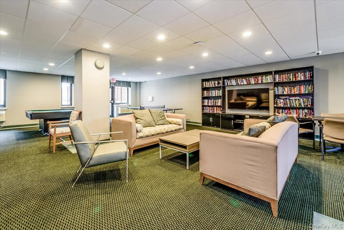 Carpeted living room featuring recessed lighting, a paneled ceiling, and billiards table Carpeted living room featuring recessed lighting, a paneled ceiling, and billiards table