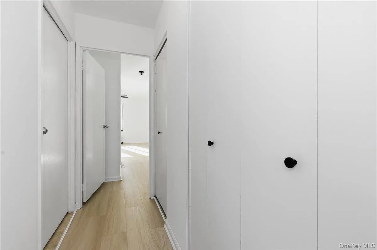 Hallway featuring light wood-type flooring Hallway featuring light wood-type flooring
