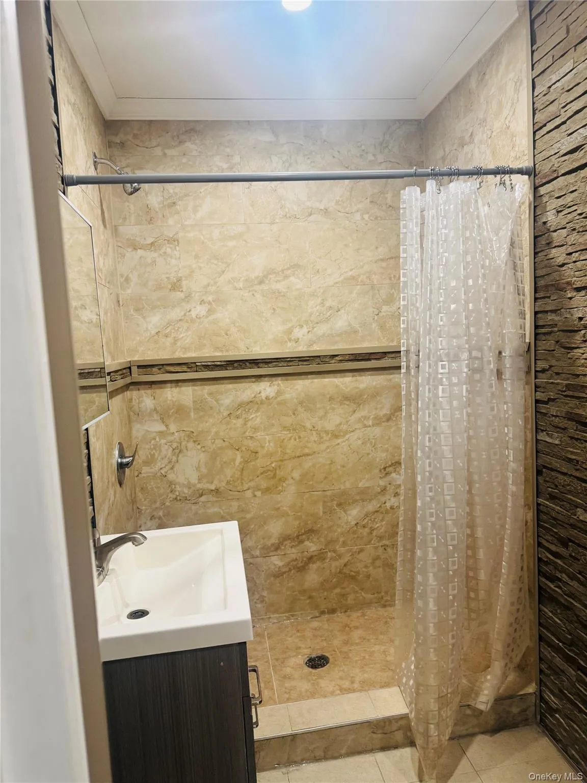 Bathroom with vanity and a stall shower Bathroom with vanity and a stall shower