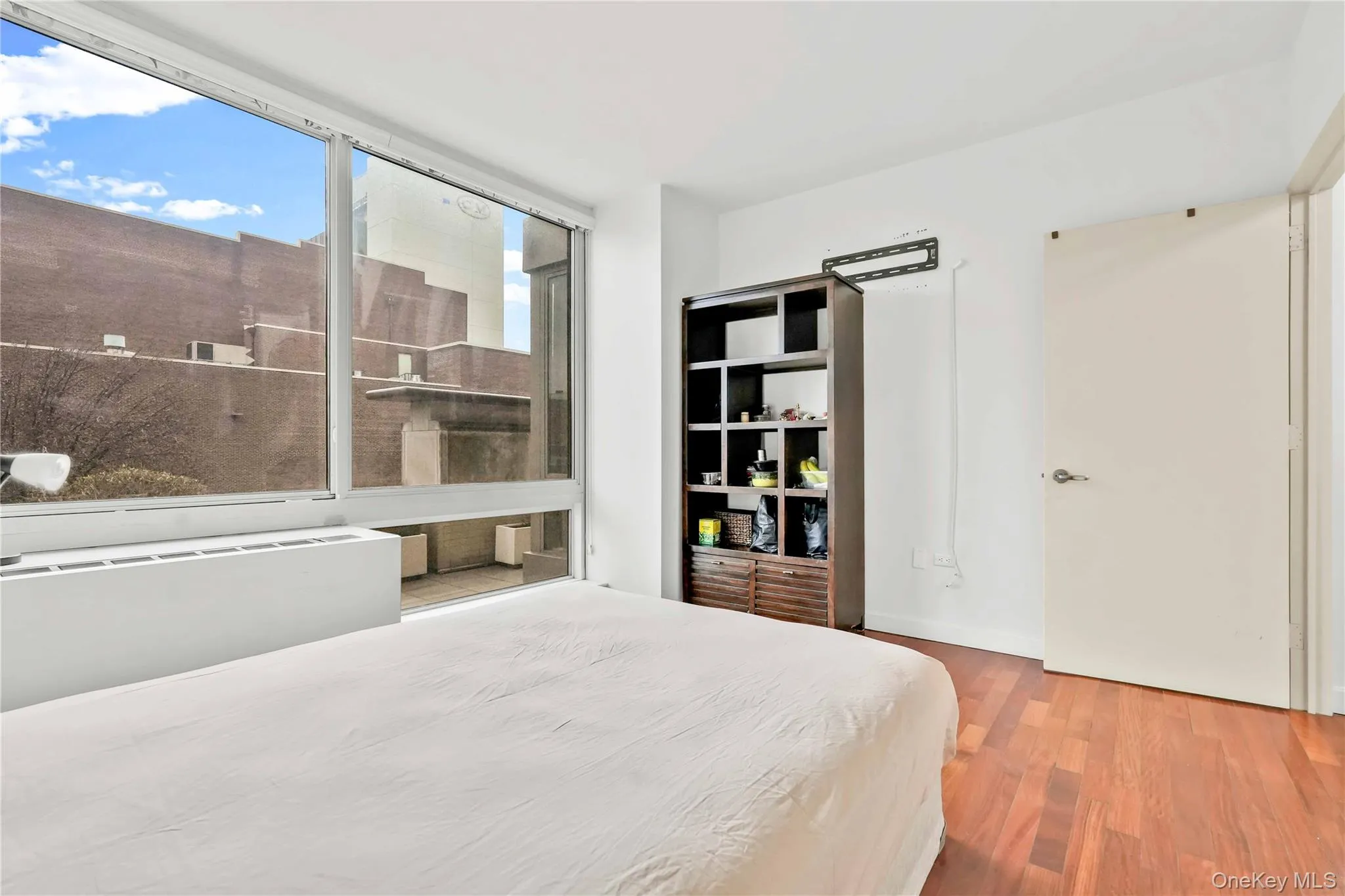 Bedroom featuring wood finished floors and baseboards Bedroom featuring wood finished floors and baseboards