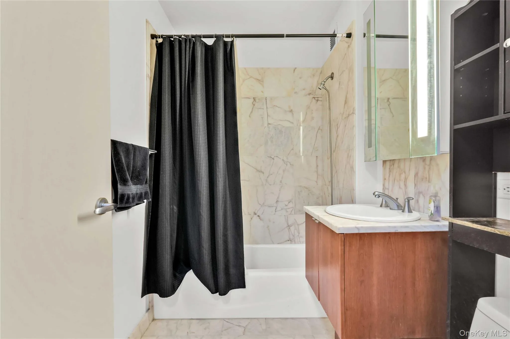 Full bath featuring shower / bath combo with shower curtain and vanity Full bath featuring shower / bath combo with shower curtain and vanity