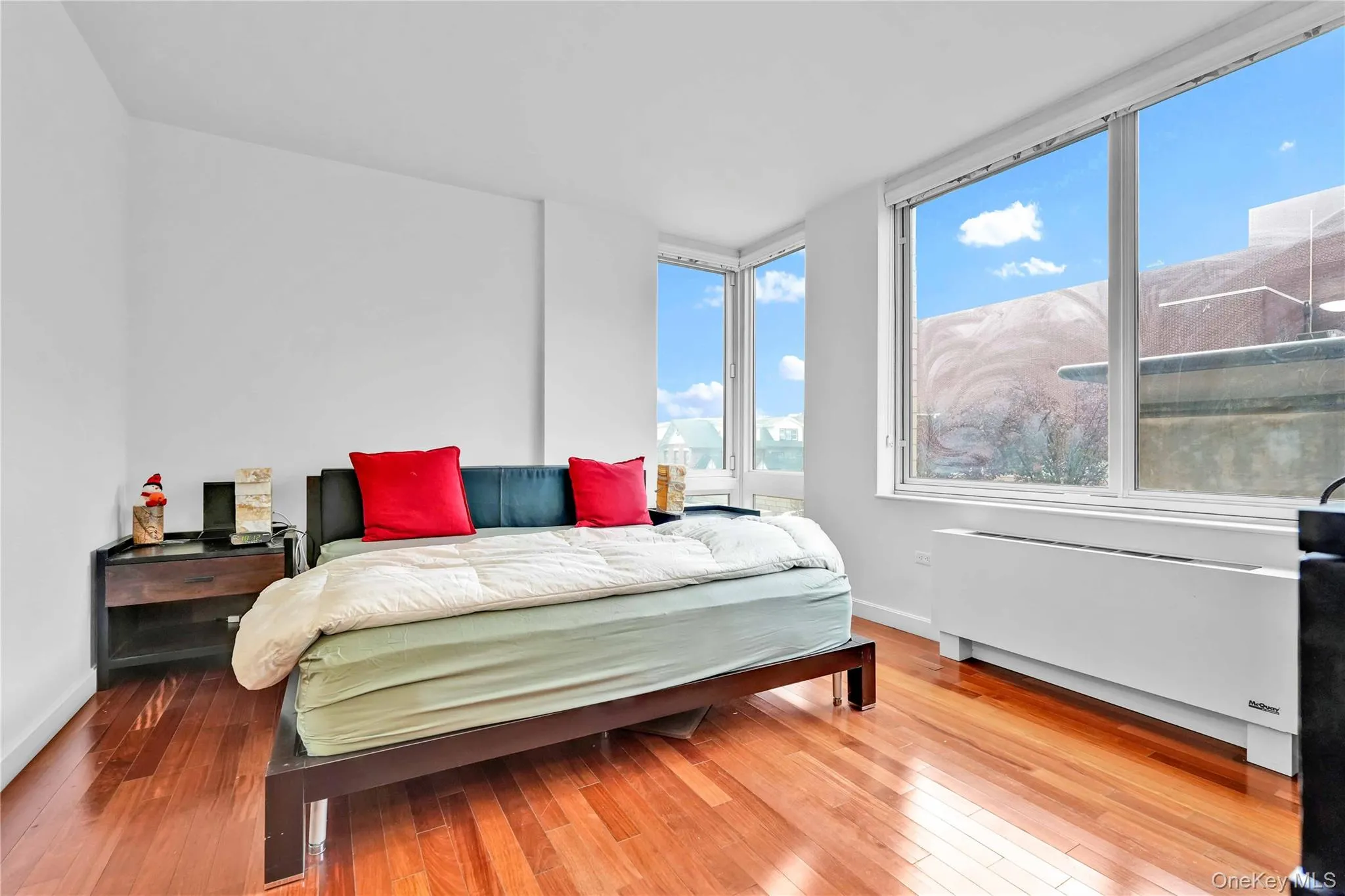 Bedroom featuring radiator and wood-type flooring Bedroom featuring radiator and wood-type flooring