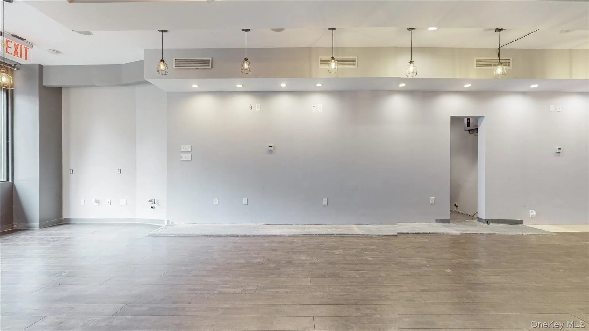 Spare room with light wood-style floors and recessed lighting Spare room with light wood-style floors and recessed lighting