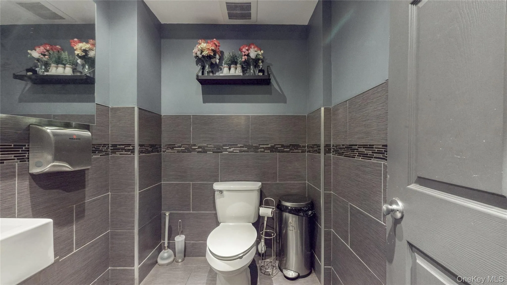 Bathroom with light tile patterned floors and tile walls Bathroom with light tile patterned floors and tile walls