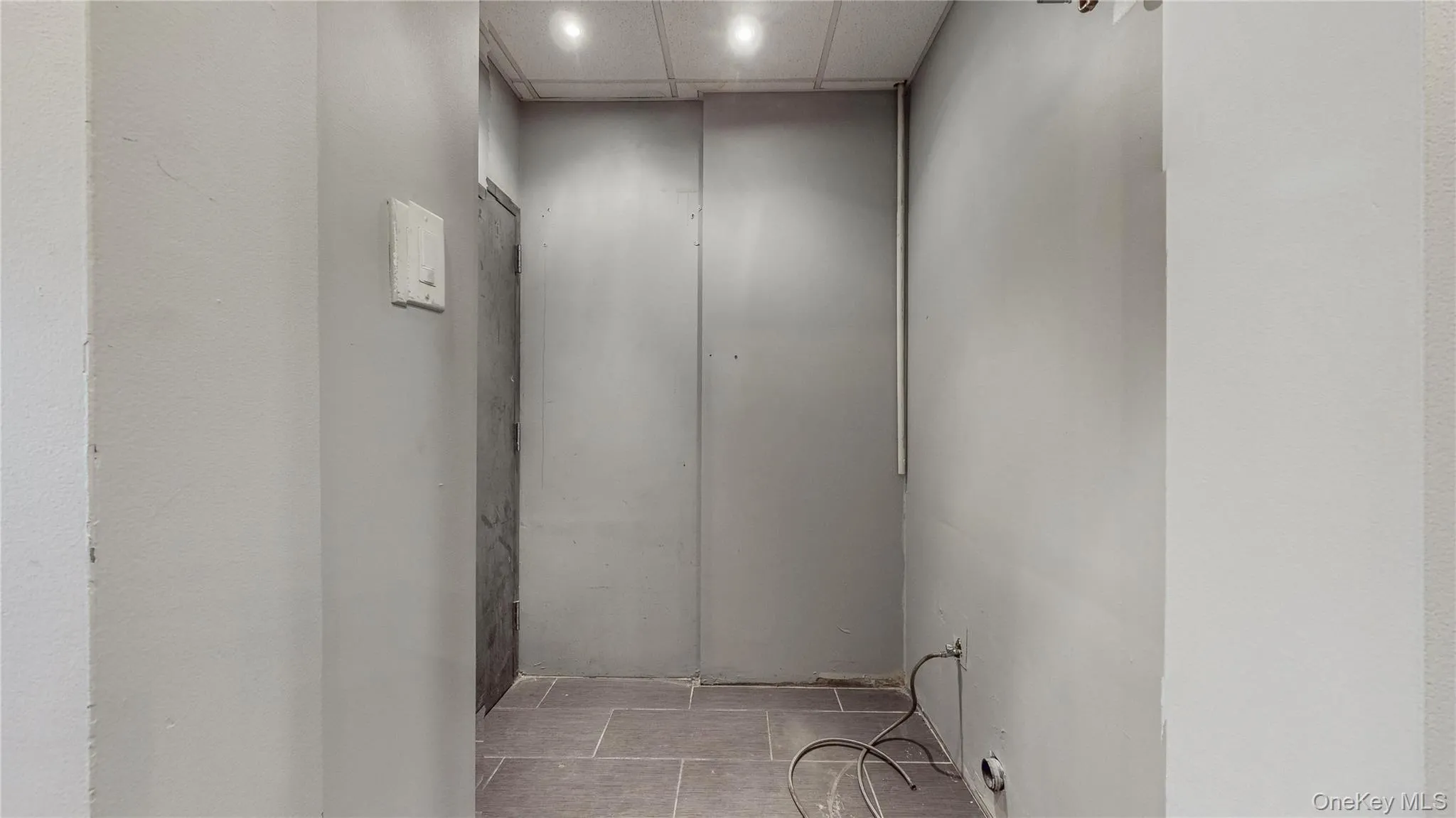 Corridor featuring a drop ceiling and recessed lighting Corridor featuring a drop ceiling and recessed lighting