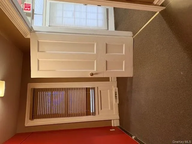 Corridor with dark carpet and baseboards Corridor with dark carpet and baseboards