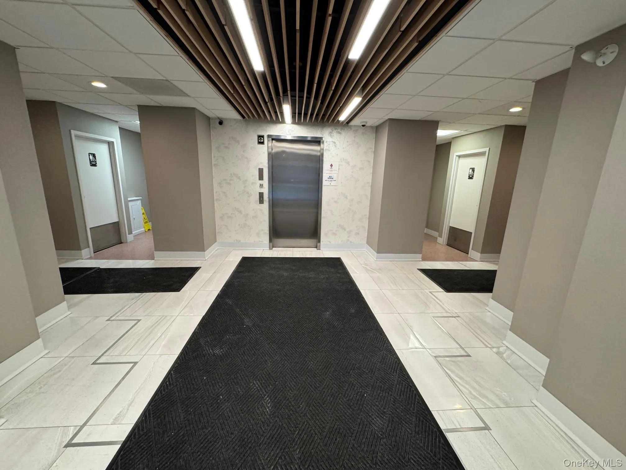 Lobby featuring a drop ceiling Lobby featuring a drop ceiling