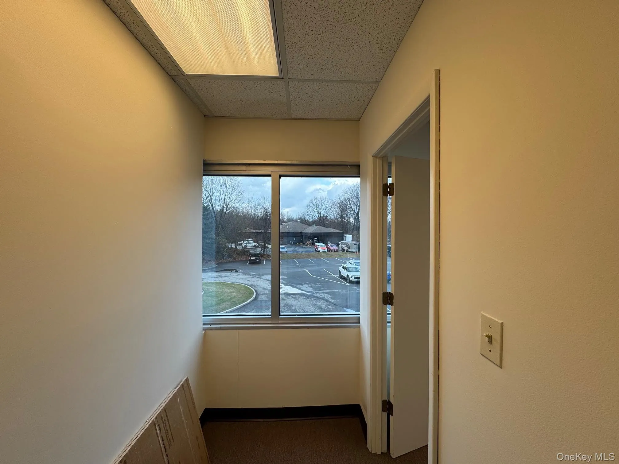 Hallway featuring a paneled ceiling Hallway featuring a paneled ceiling