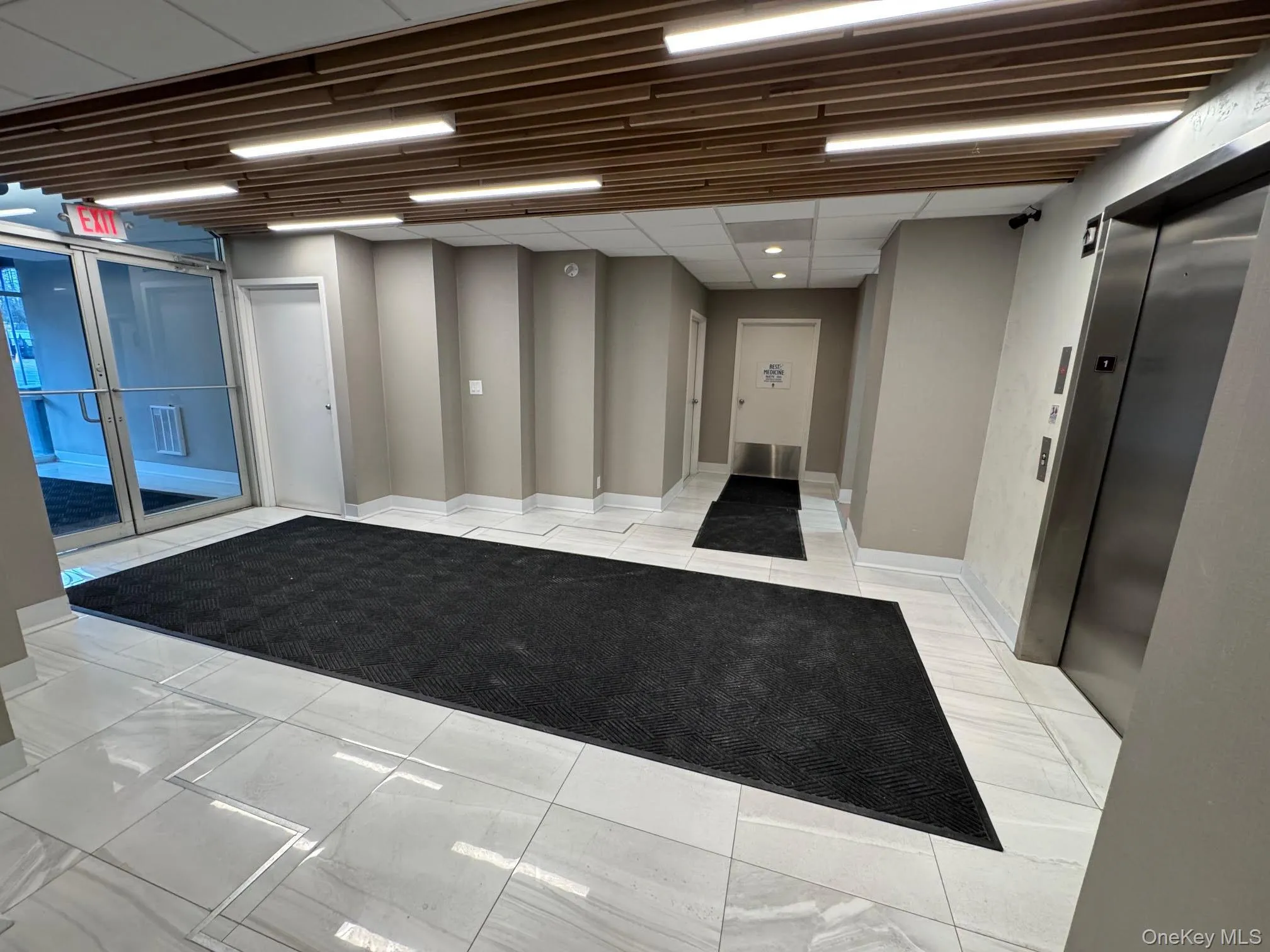 Building lobby featuring a paneled ceiling Building lobby featuring a paneled ceiling