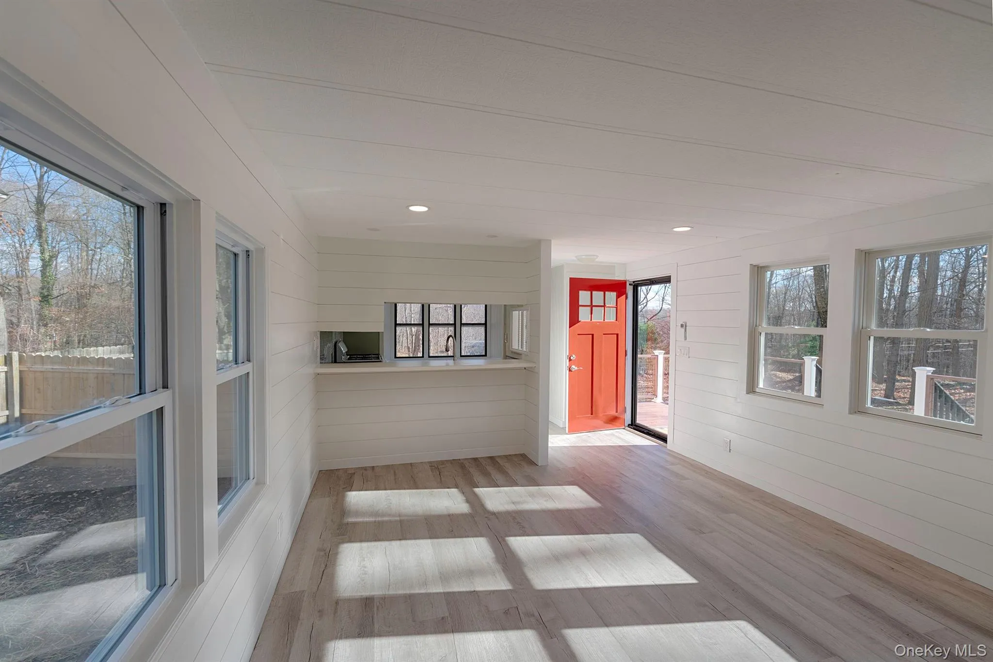 Unfurnished sunroom with wood finished floors, wood walls, and recessed lighting Unfurnished sunroom with wood finished floors, wood walls, and recessed lighting