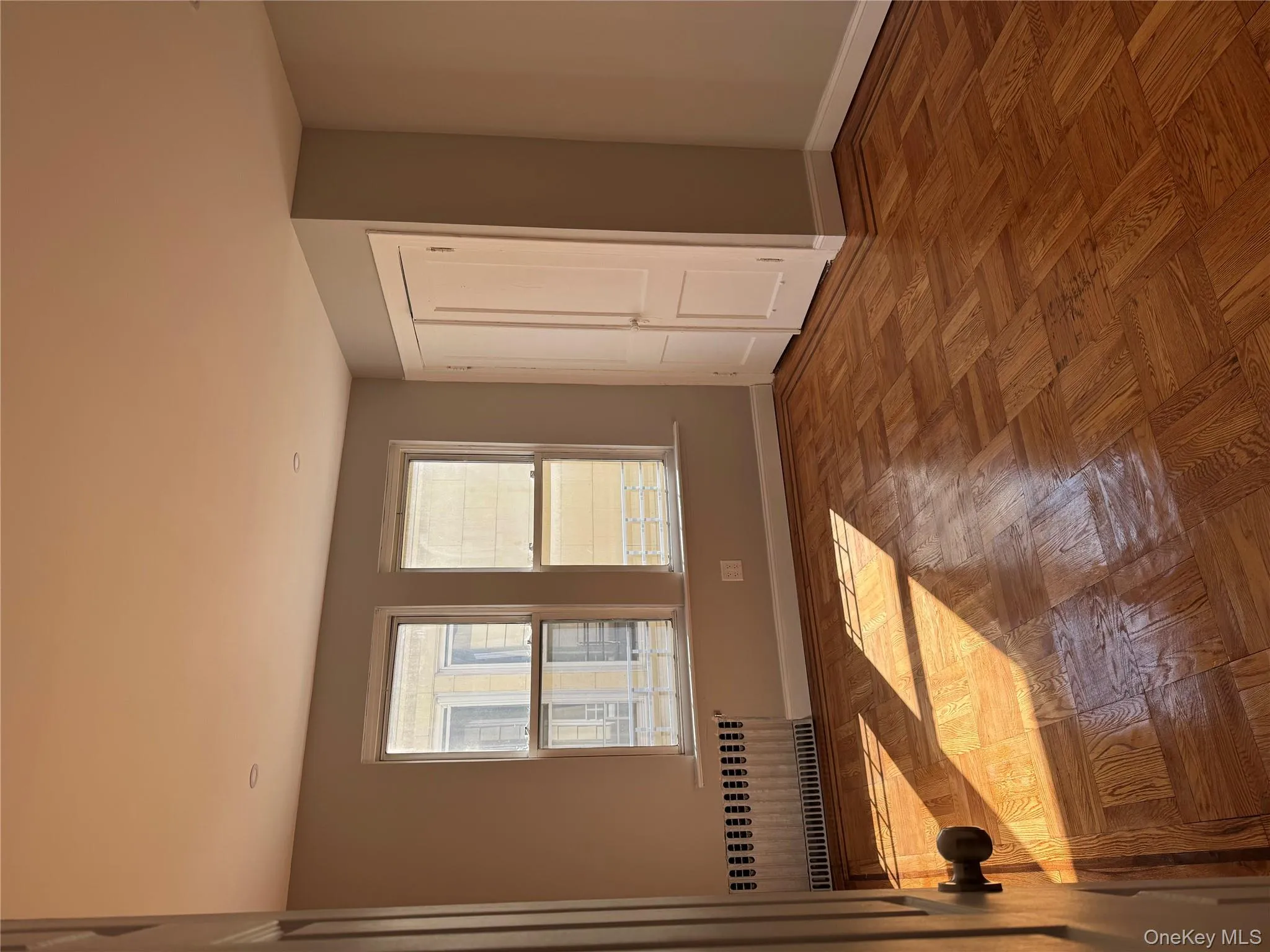 Unfurnished room with radiator and baseboards Unfurnished room with radiator and baseboards