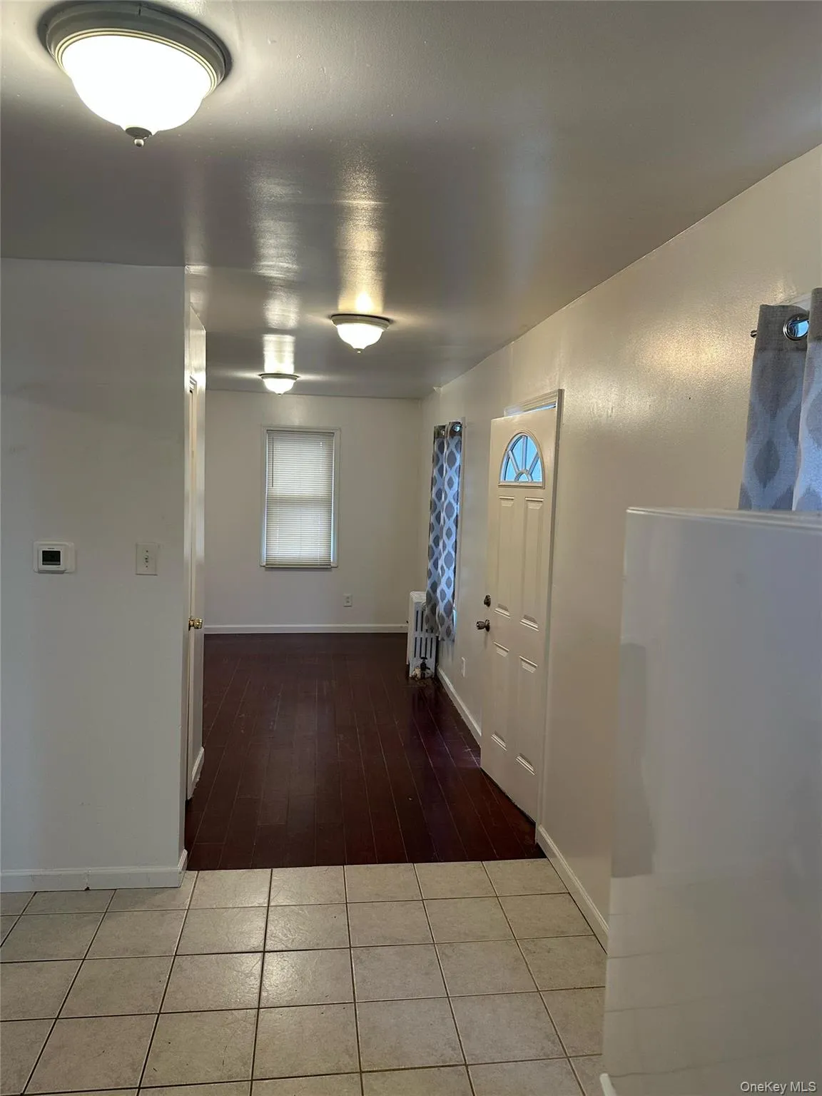 Entryway featuring baseboards and dark tile patterned flooring Entryway featuring baseboards and dark tile patterned flooring