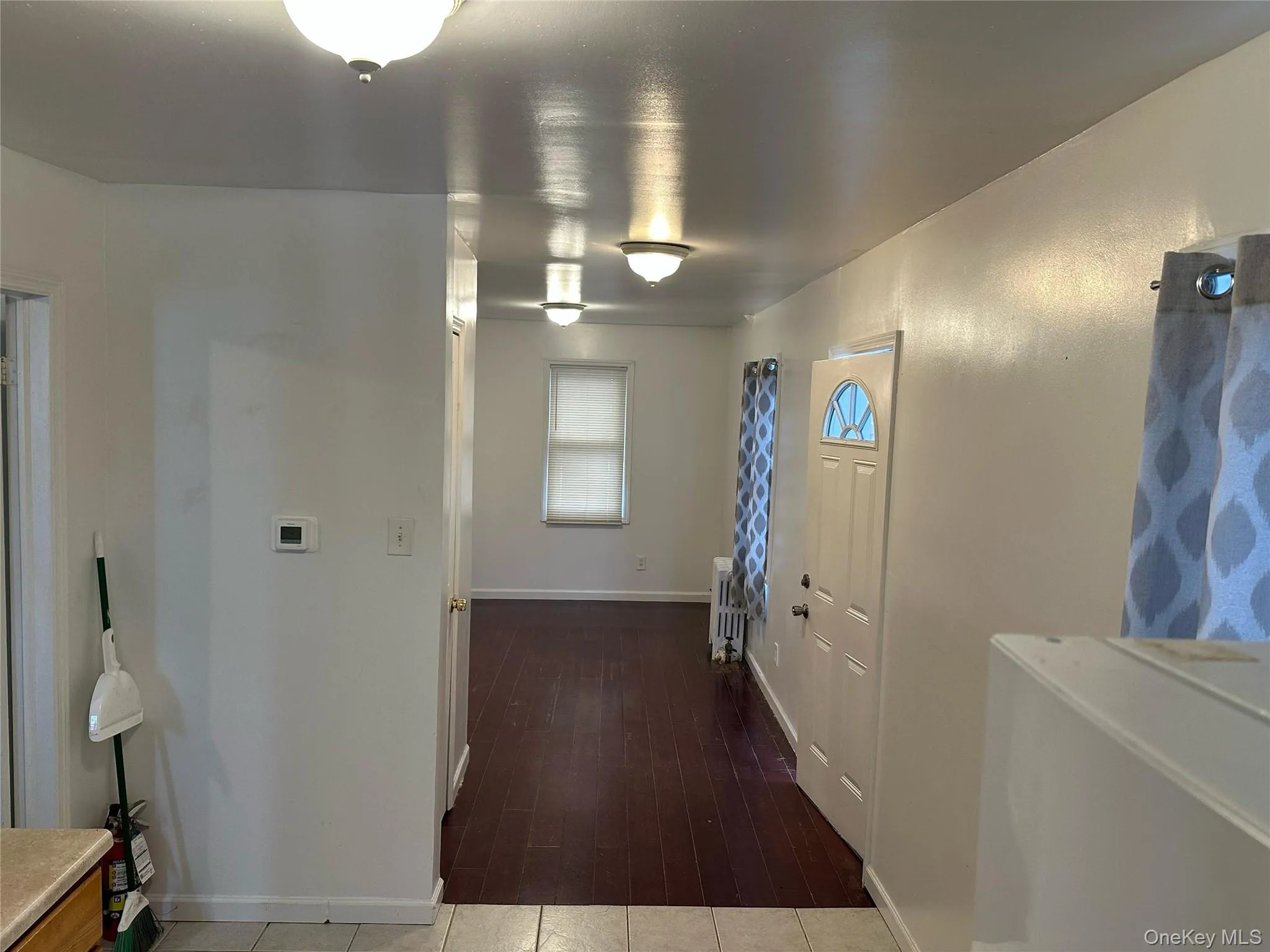 Entryway with baseboards and dark wood finished floors Entryway with baseboards and dark wood finished floors